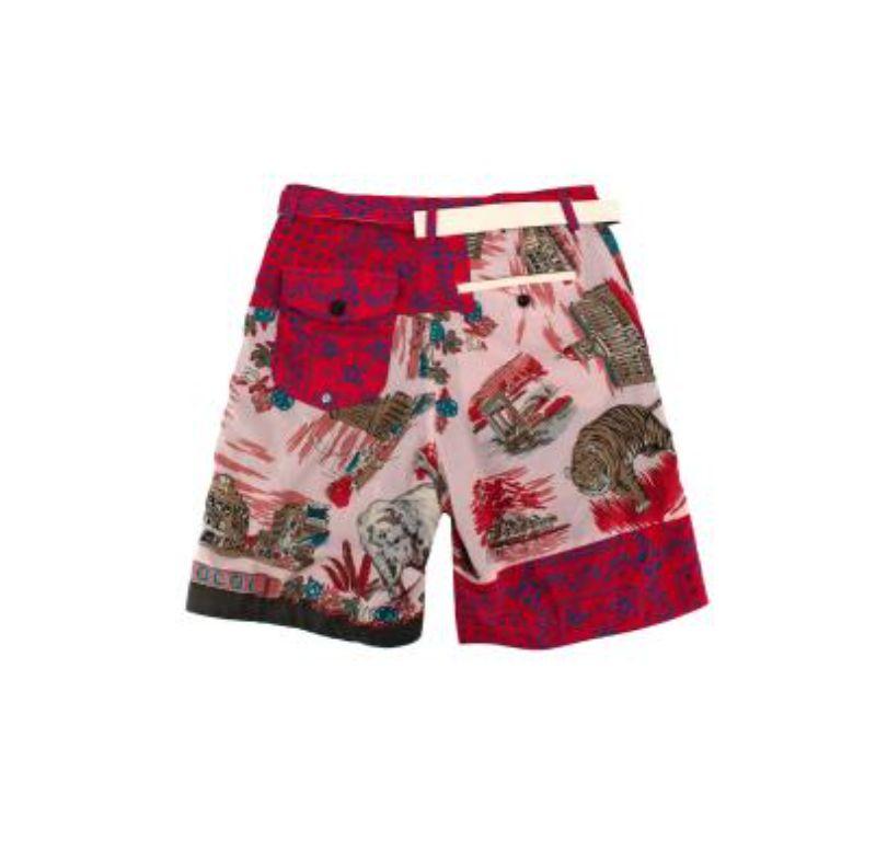 Sacai Red Multi-Print Cotton Shorts

-Button & zip fastening 
-Belt loops 
-Adjustable printed belt around waist 
- Floral & tiger print design 
- Fully lined 
-One pocket at the waist & two buttoned pockets at the back 

Material: 

Cotton