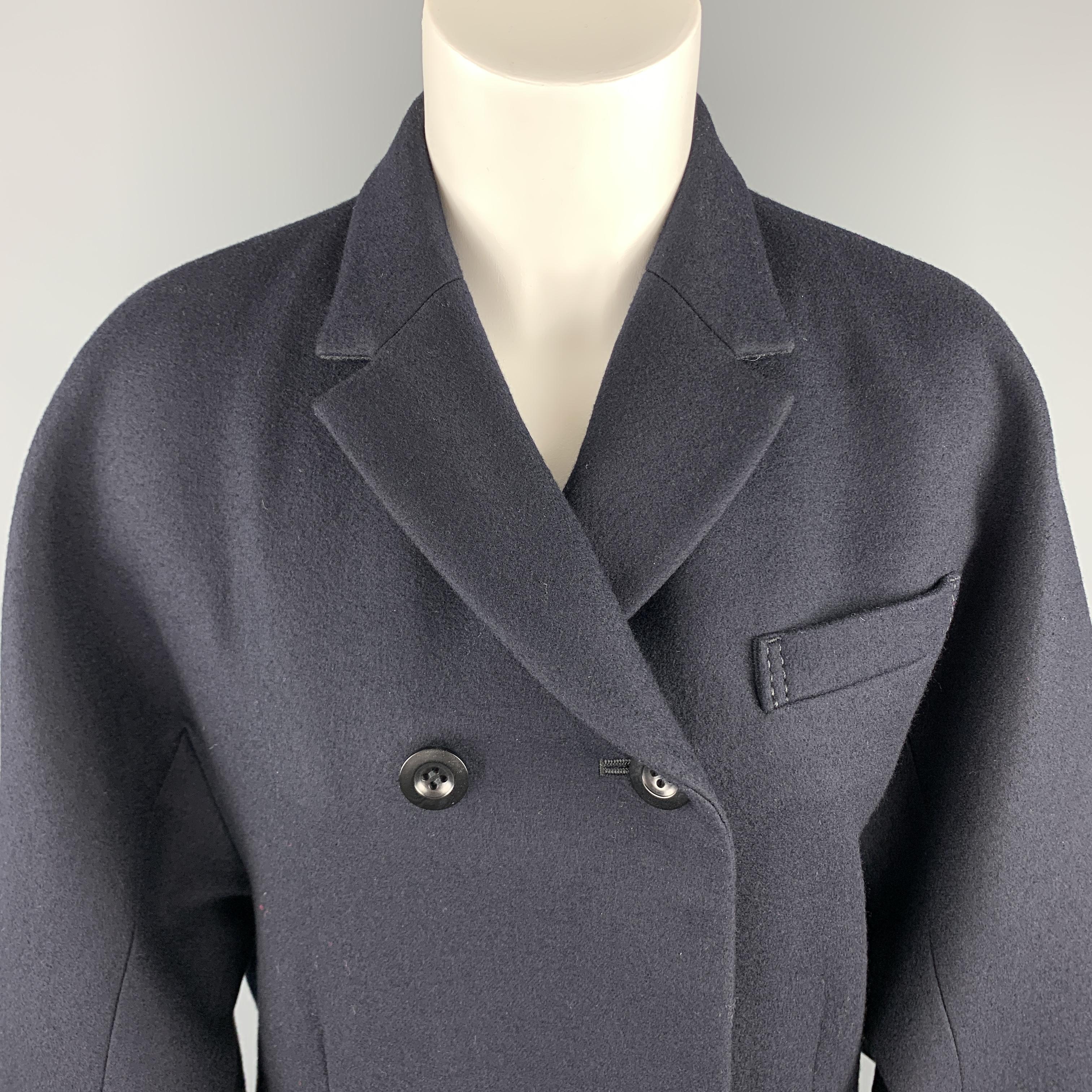 SACAI coat comes in navy wool with a notch lapel, double breasted hidden placket button front, over sized tab cuff sleeves, and asymmetrical zip closure leather panel with belted accents. Made in Japan.

Excellent Pre-Owned Condition.
Marked: JP