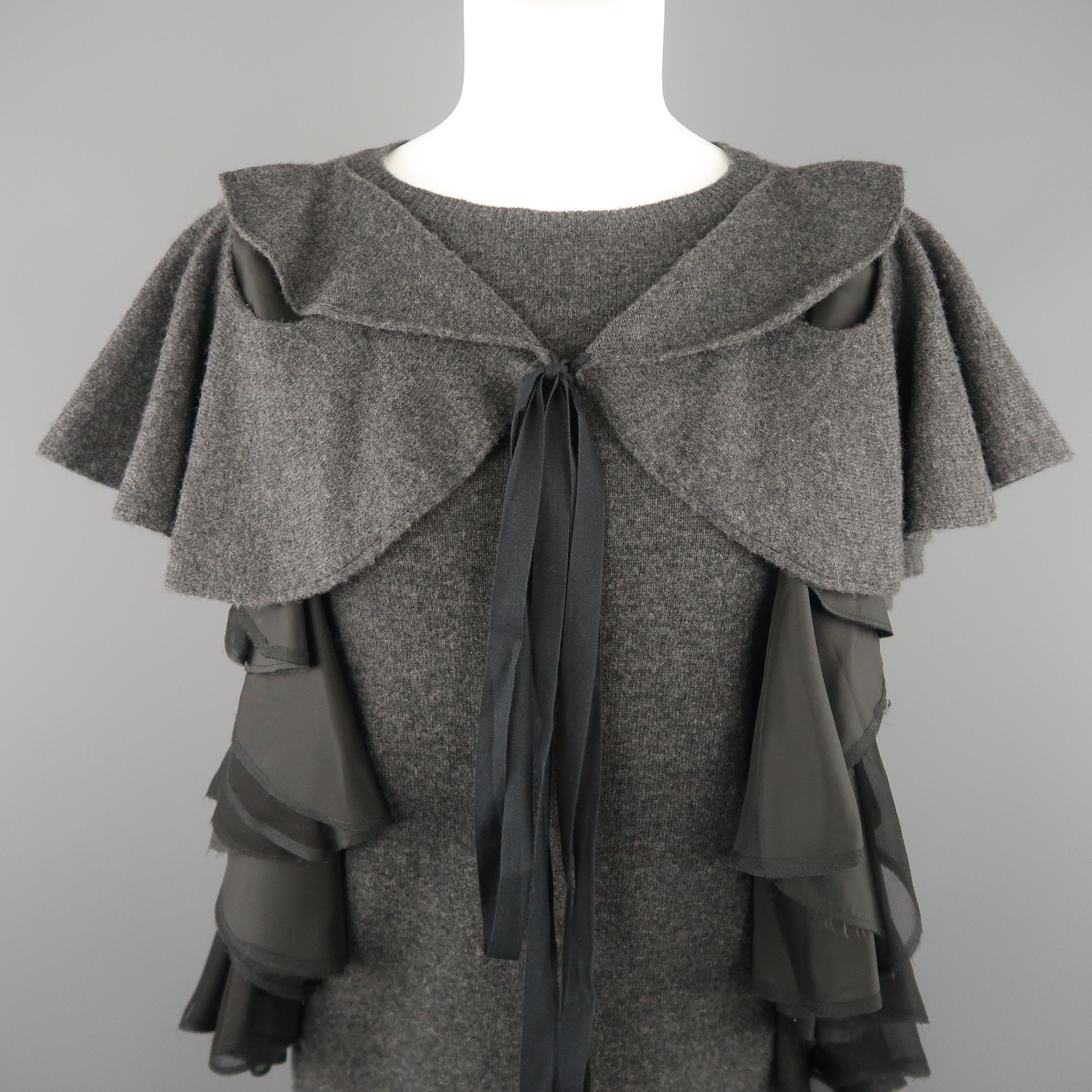 SACAI sweater shift sac dress comes in dark heather wool knit with a crewneck, ruffled sleave overlay that ties in front, and silk chiffon and satin ruffled side accents. Made in Japan.
 
Excellent Pre-Owned Condition.
Marked: JP 2
 
Measurements:
