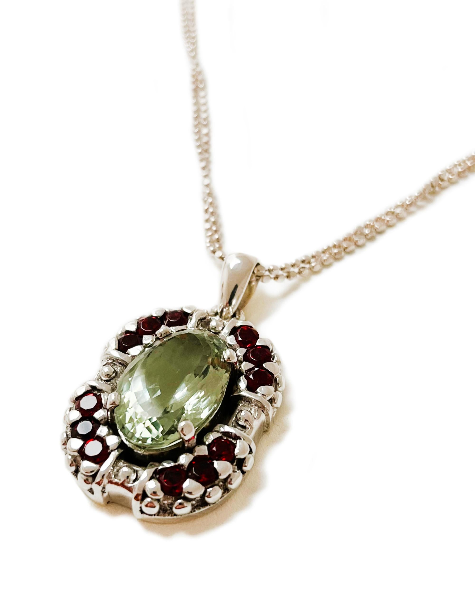 Design:This highly textured piece derives its interest from contrast and craftsmanship. The beaded, tarnish- resistant Argentium silver chain provides a nice complement to the prasiolite and garnet pendant that swings below. It, too, is beaded to