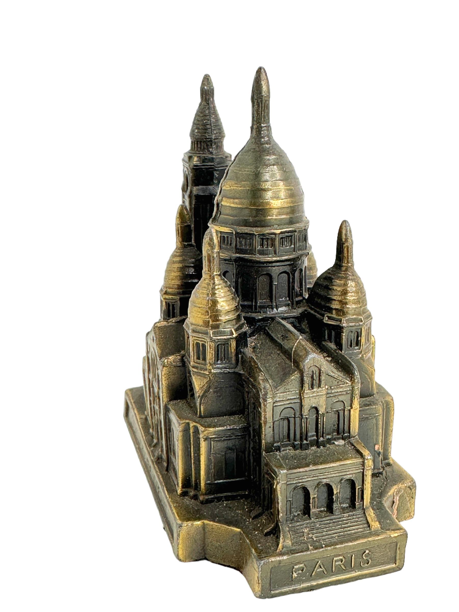 A decorative building sculpture as a souvenir. Some wear with a nice patina, but this is due to age. Made of metal. This item was purchased as a souvenir in Paris, France and was probably made in the 1950s or earlier. Found at an estate sale in