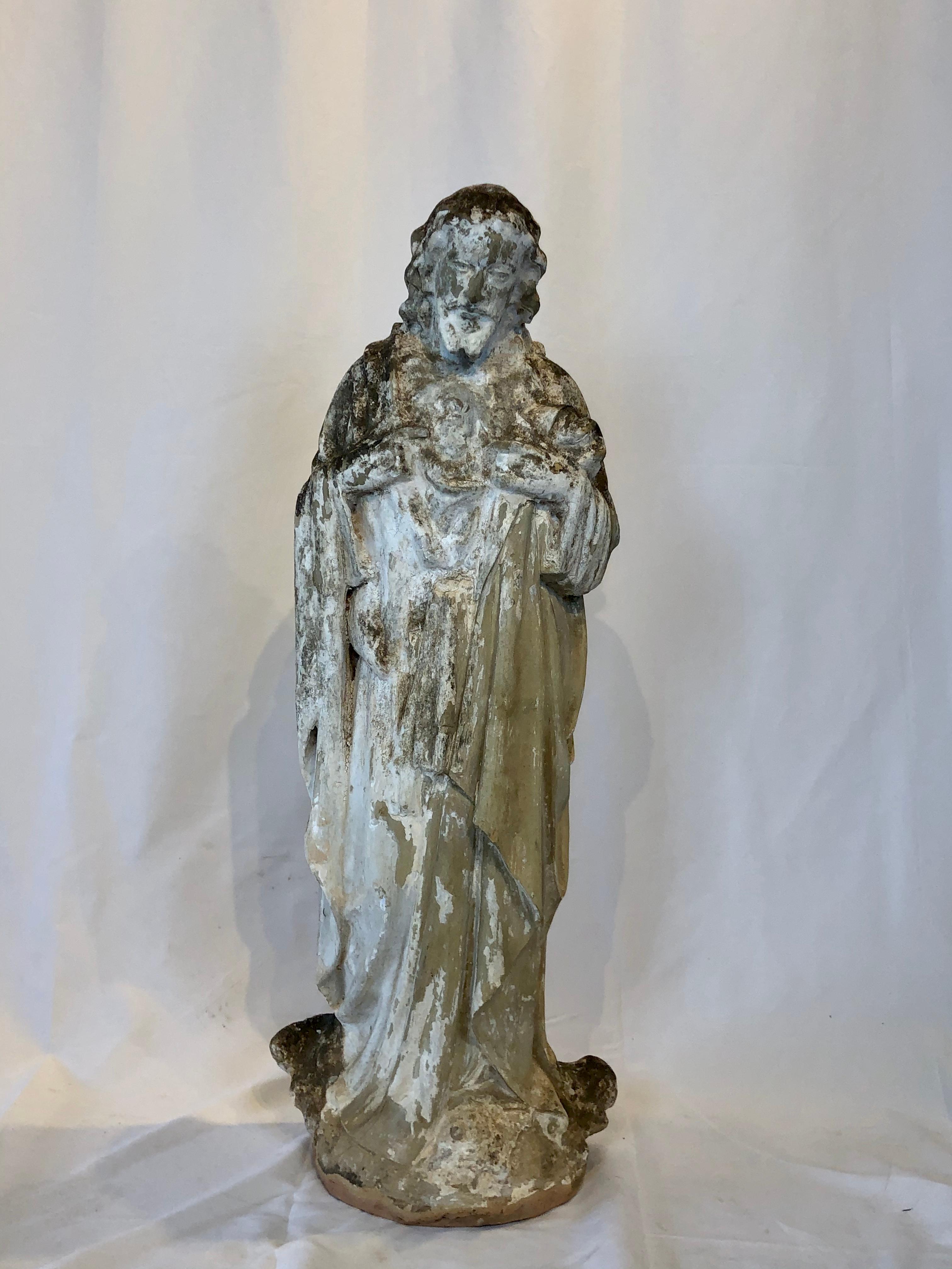Found in France, this is a terracotta statue of The Sacred Heart of Jesus. We believe this statue was once used outside of a French church. The paint has worn leaving a wonderful aged patina. This beautiful statue could be used in your home or