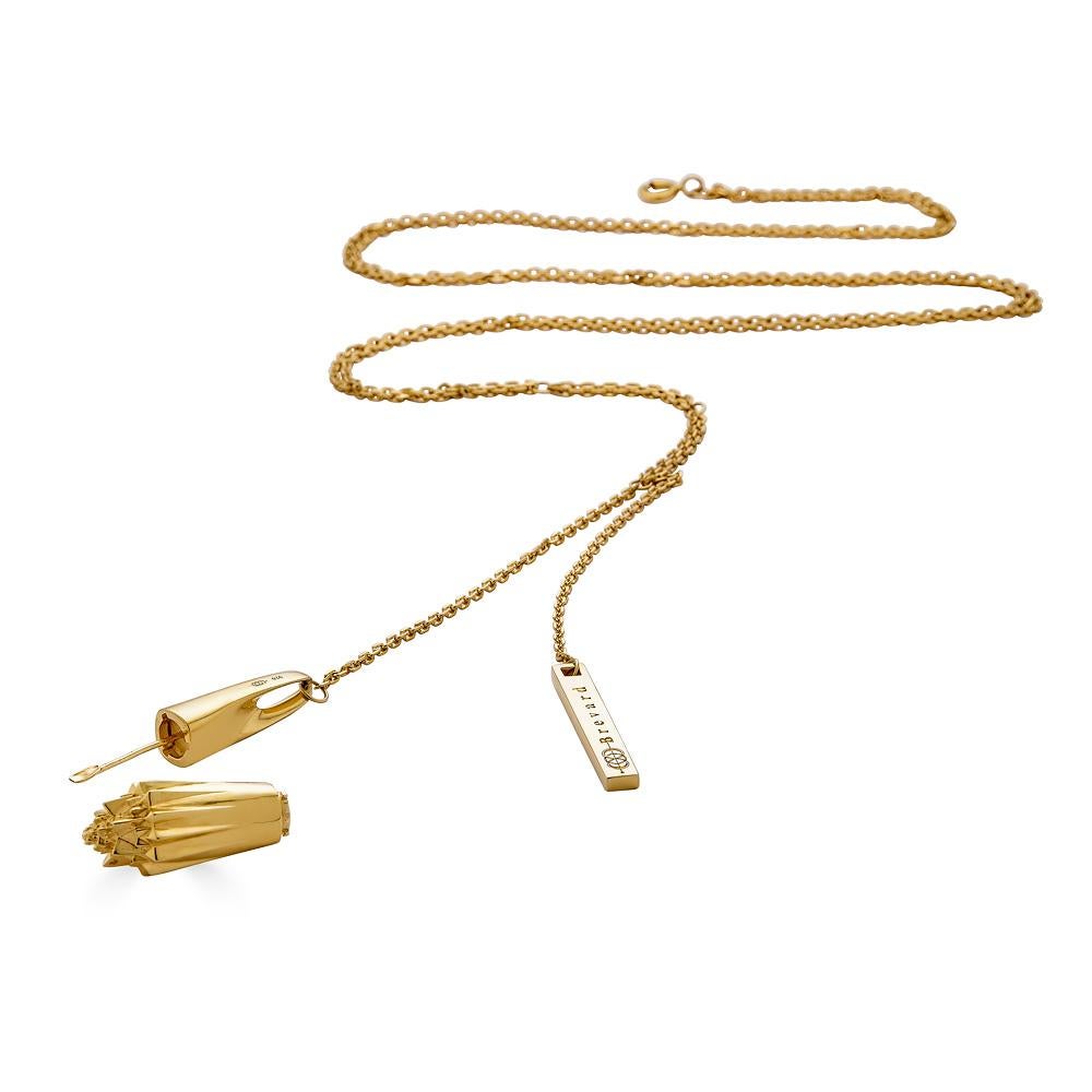 The Sacred Medicine 18K Gold Necklace hides a spoon hidden inside a screw-top compartment. The necklace is part of the Thoscene collection. The collection is inspired by fractals found in ancient art and architecture, including ruins of the