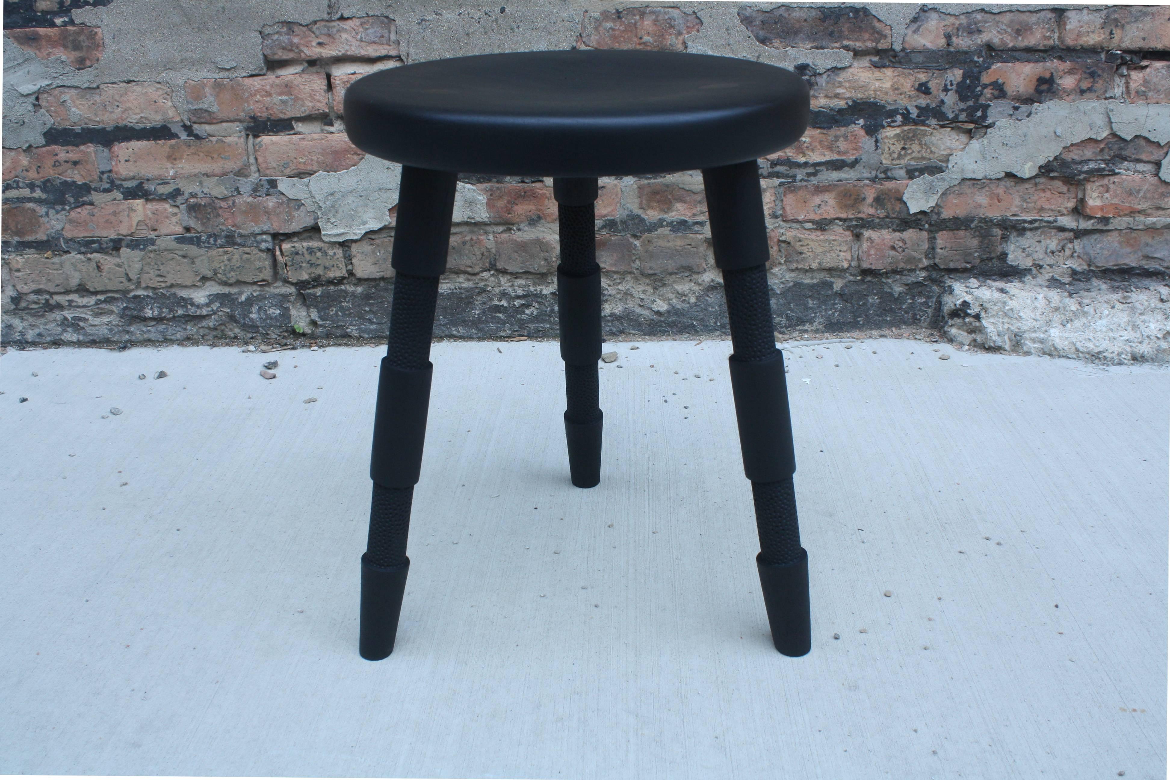 Ebonized Saddle, Handmade Wood Stool with Textured Legs and a Carved Seat For Sale