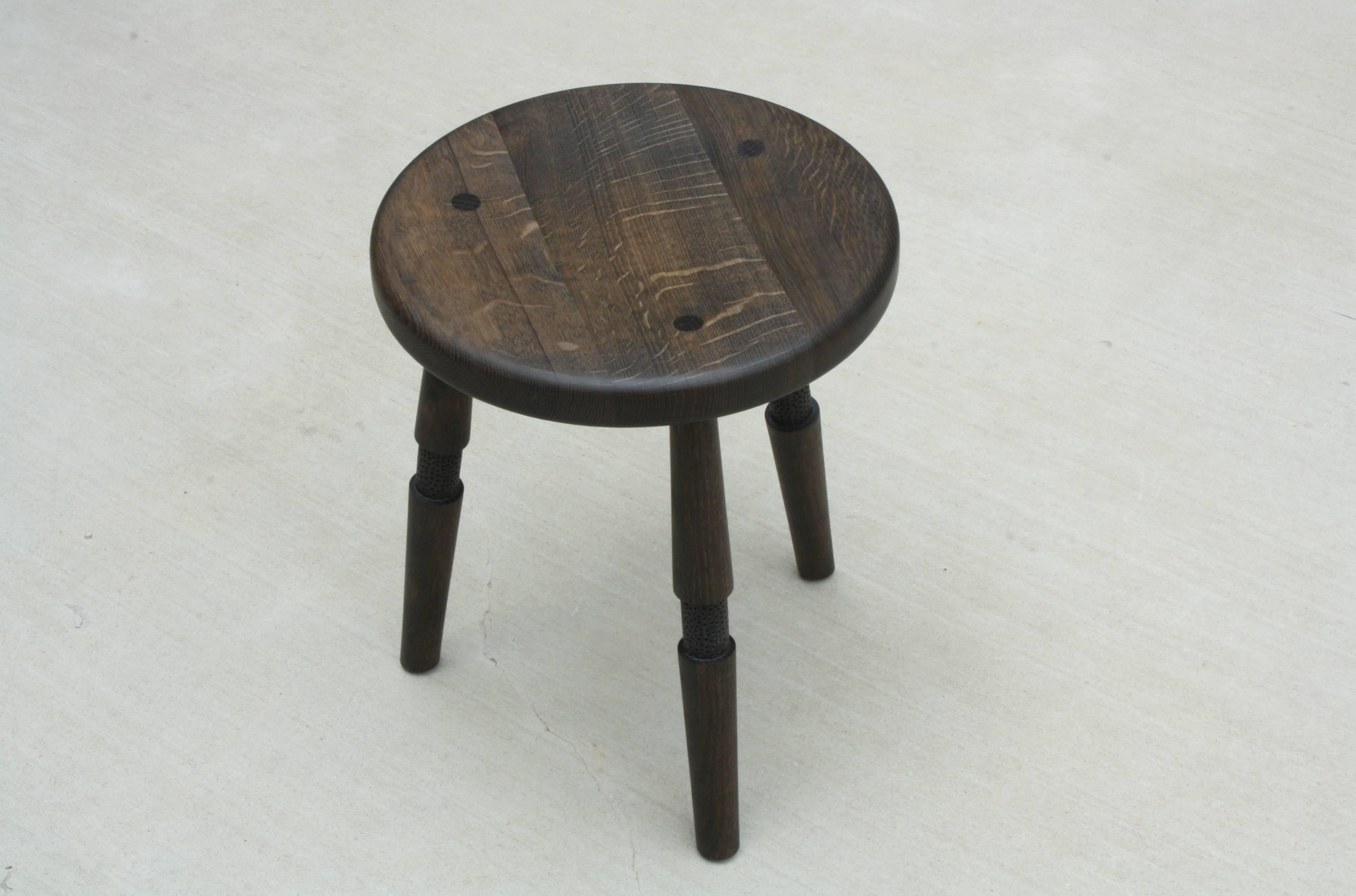 Handmade in Chicago by Laylo Studio, this solid wood stool features turned and textured legs that are joined to the hand-carved seat using through wedged, tapered tenons - a method of joinery found in Windsor chairs. The joinery locking the legs in