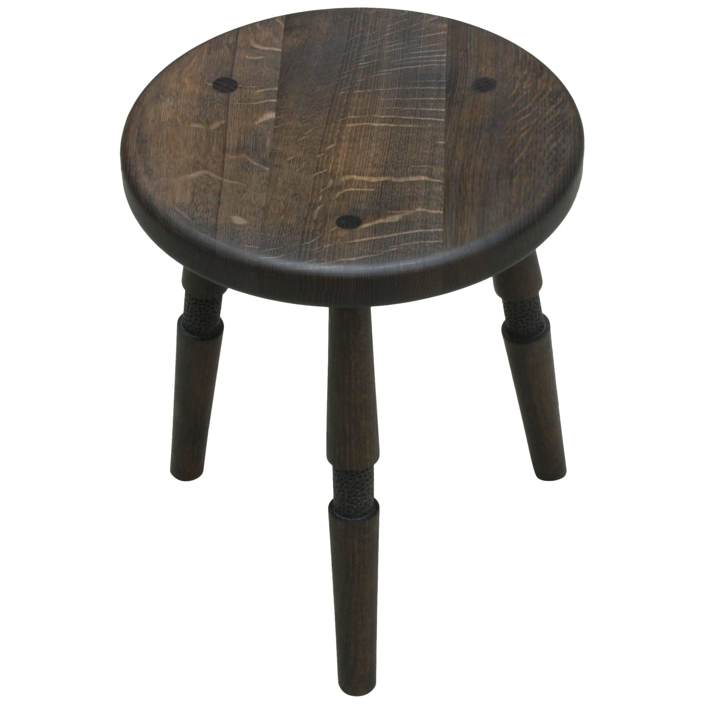 Saddle, Handmade Oxidized Oak Stool with Textured Legs and a Carved Seat For Sale