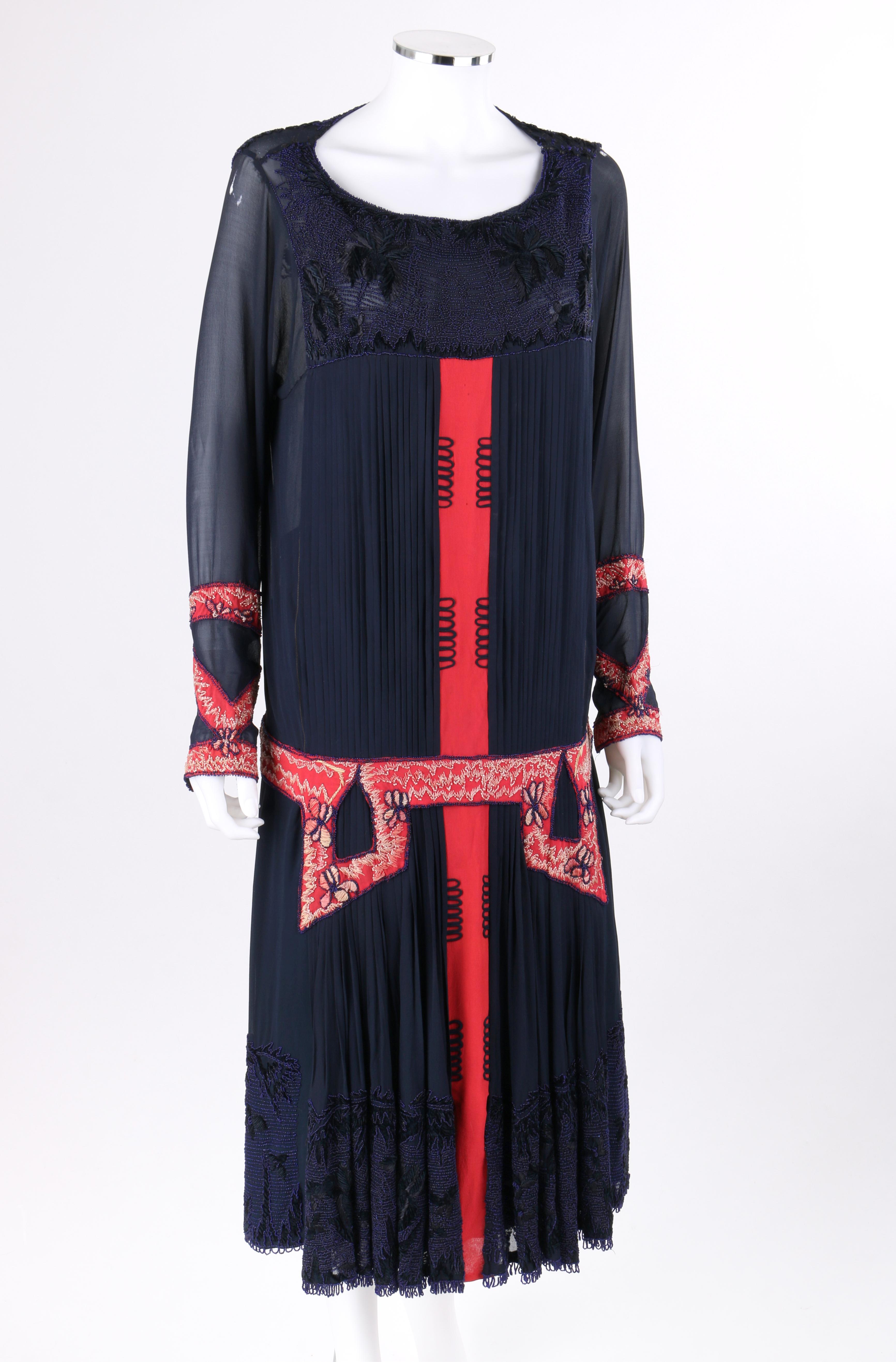 SADIE NEMSER c.1920’s Art Deco Silk Beaded Embroidered Cubist Flapper Couture Dress

Circa: 1920’s
Label(s): Nemser Original Model  
Style: Drop waist dress
Color(s): Shades of navy blue, dark pink and tan
Lined: Yes
Unmarked Fabric Content: Silk