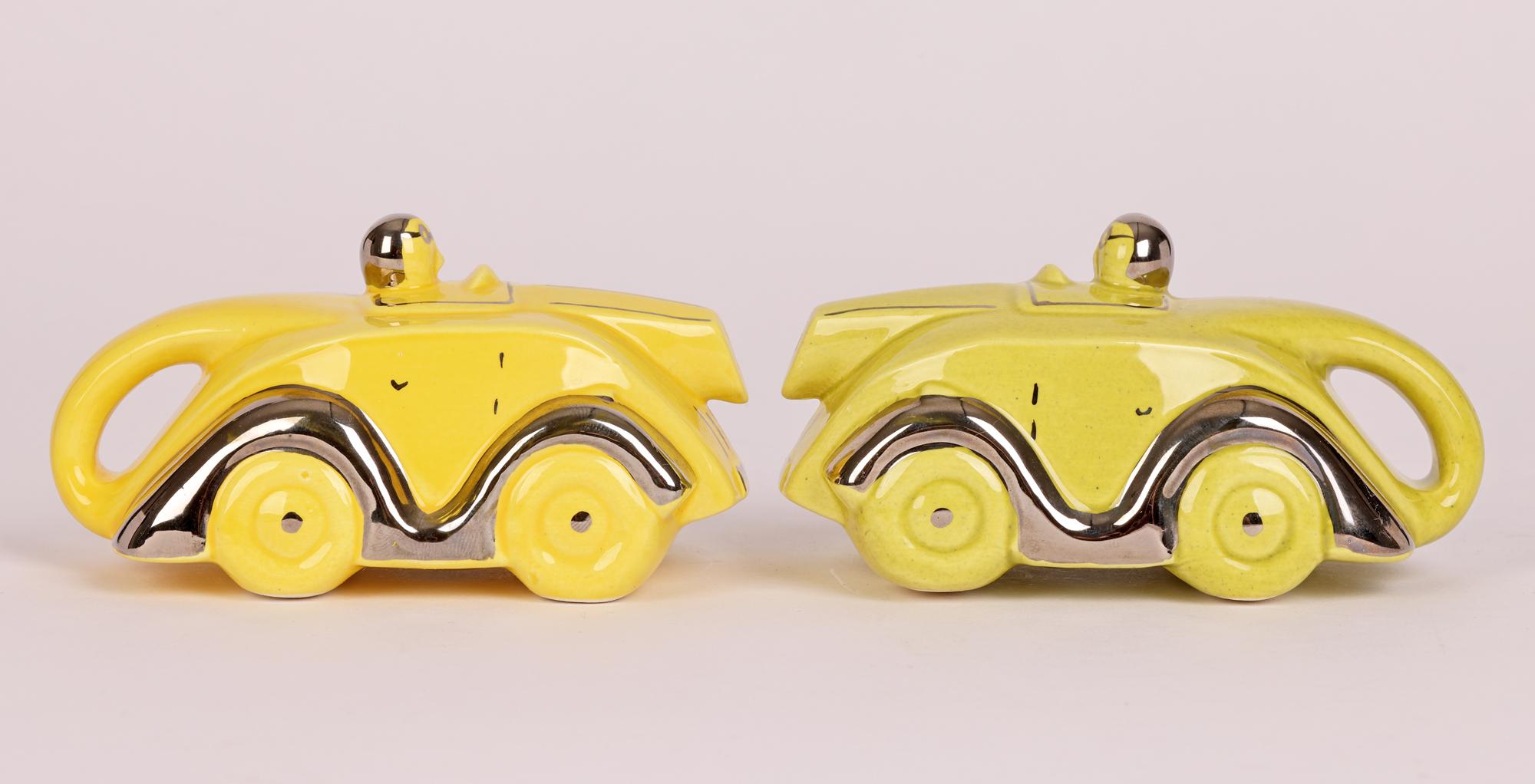 A delightful novelty pair of Art Deco style ceramic cruets modelled as racing cars made by in Staffordshire by Regina Industries and dating from around 1970. The cruets are based on the art deco designs by James Sadler of their racing car teapot