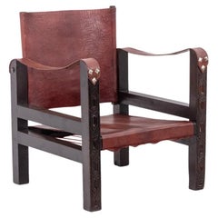 “Safari” armchair in wood and cognac leather. 1960s/70s.