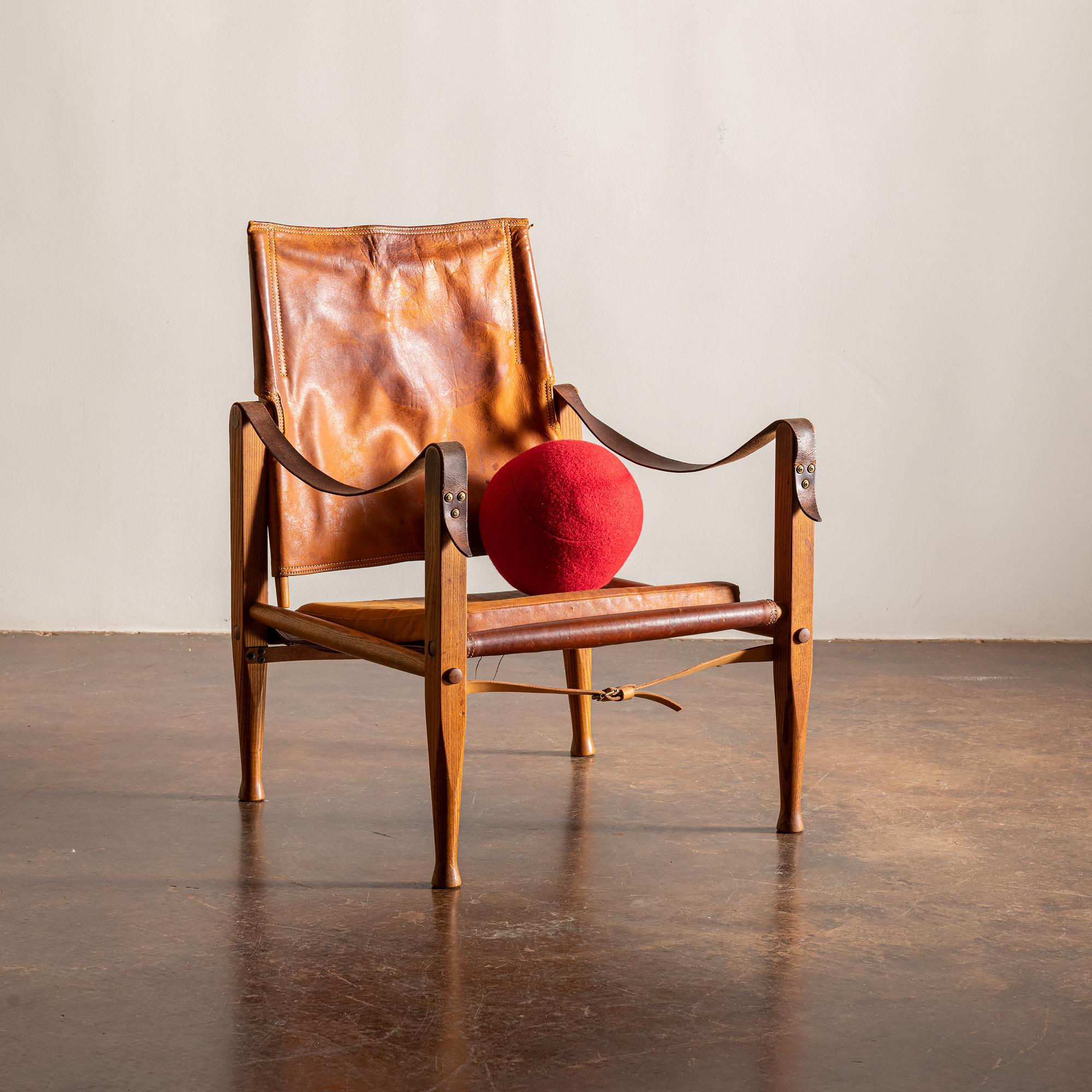 The iconic safari chair by Kaare Klint. This example in stained ash beautifully patinated cognac leather. For Rud Rasmussen, Denmark, 1960s.