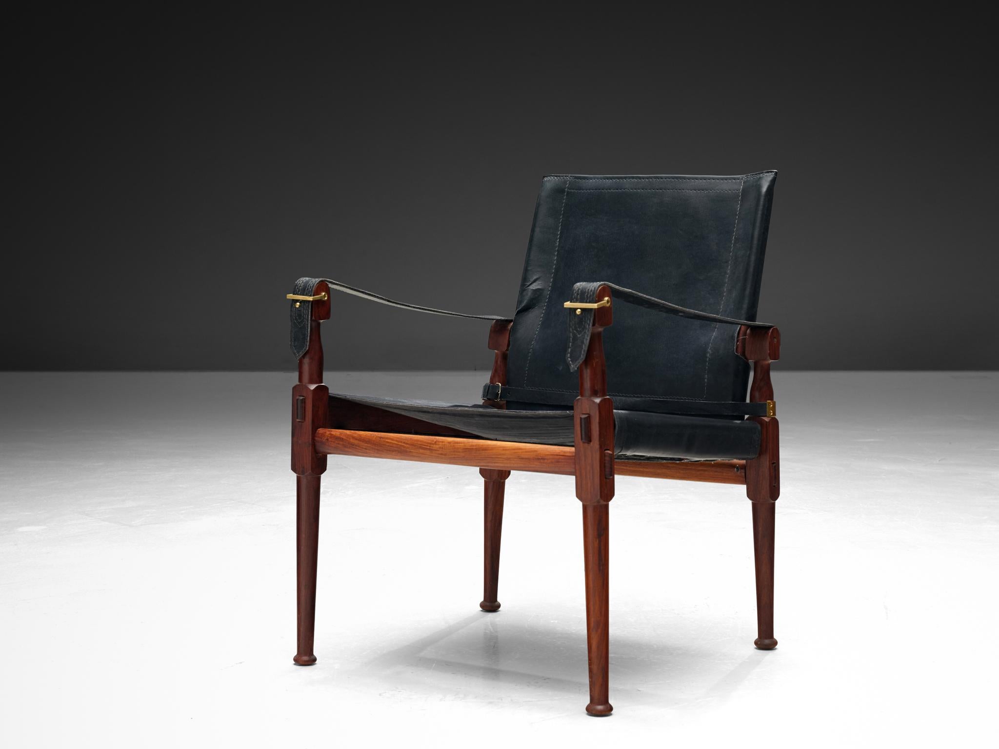 M. Hayat & Brothers Pakistani, 'Safari' lounge chair, leather, stained wood, brass, Pakistan, 1970s 

This Safari-inspired armchair exemplifies refined elegance through its meticulously designed lines and expertly crafted wood joints. The luxurious