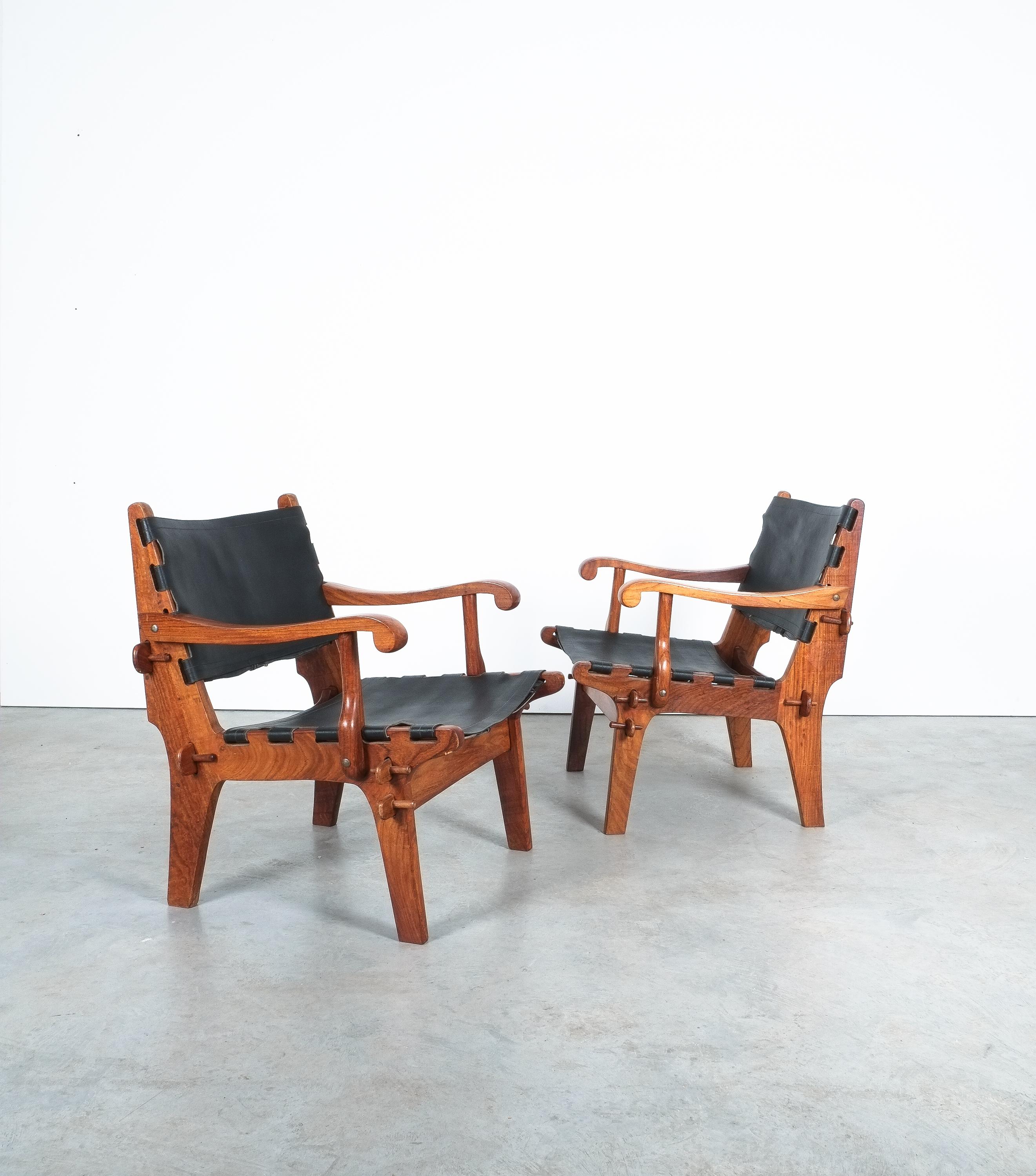 Pair of lounge armchairs designed in 1960s by Angel I. Pazmino and manufactured by Muebles de Estilo in Ecuador.

A stunning and rare pair of vintage safari chairs in solid rosewood and leather. Ecuadorian designer Angel Pazmino has created a