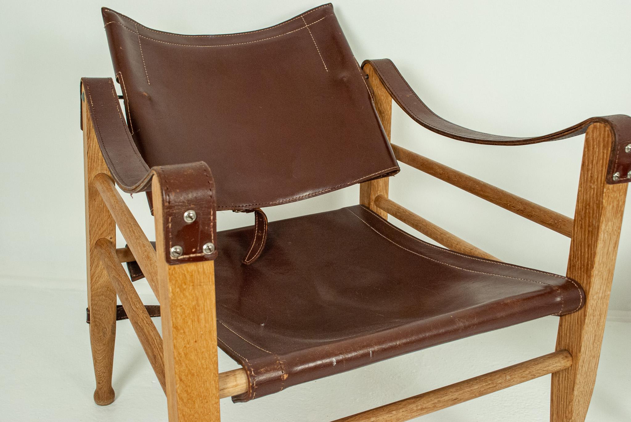 A pair of safari chairs by Aage Bruun & Son of black leather and soap treated beech from the 1960s.
