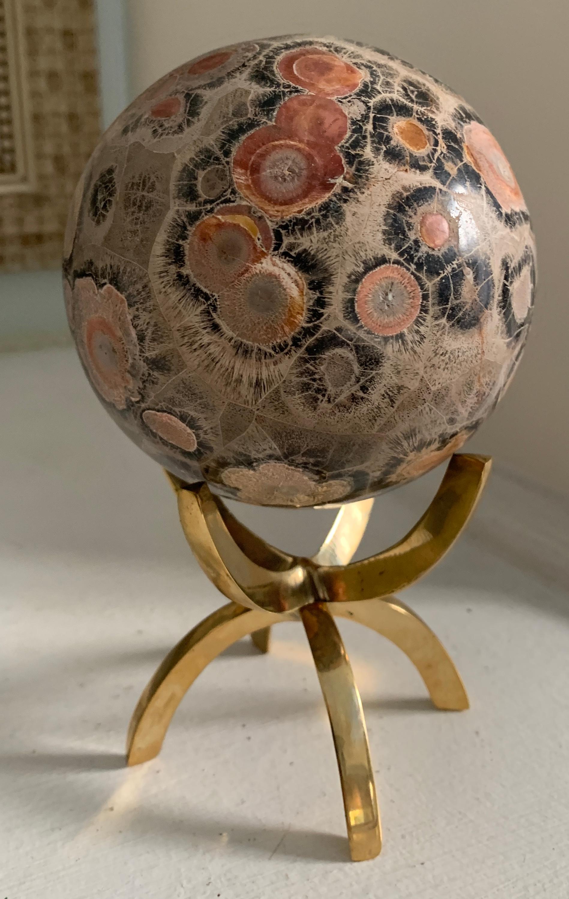 A wonderful specimen on a four pronged brass stand. A wonderful decorative object for any shelf or desk and well suited as a paperweight on the most sophisticated of desks.