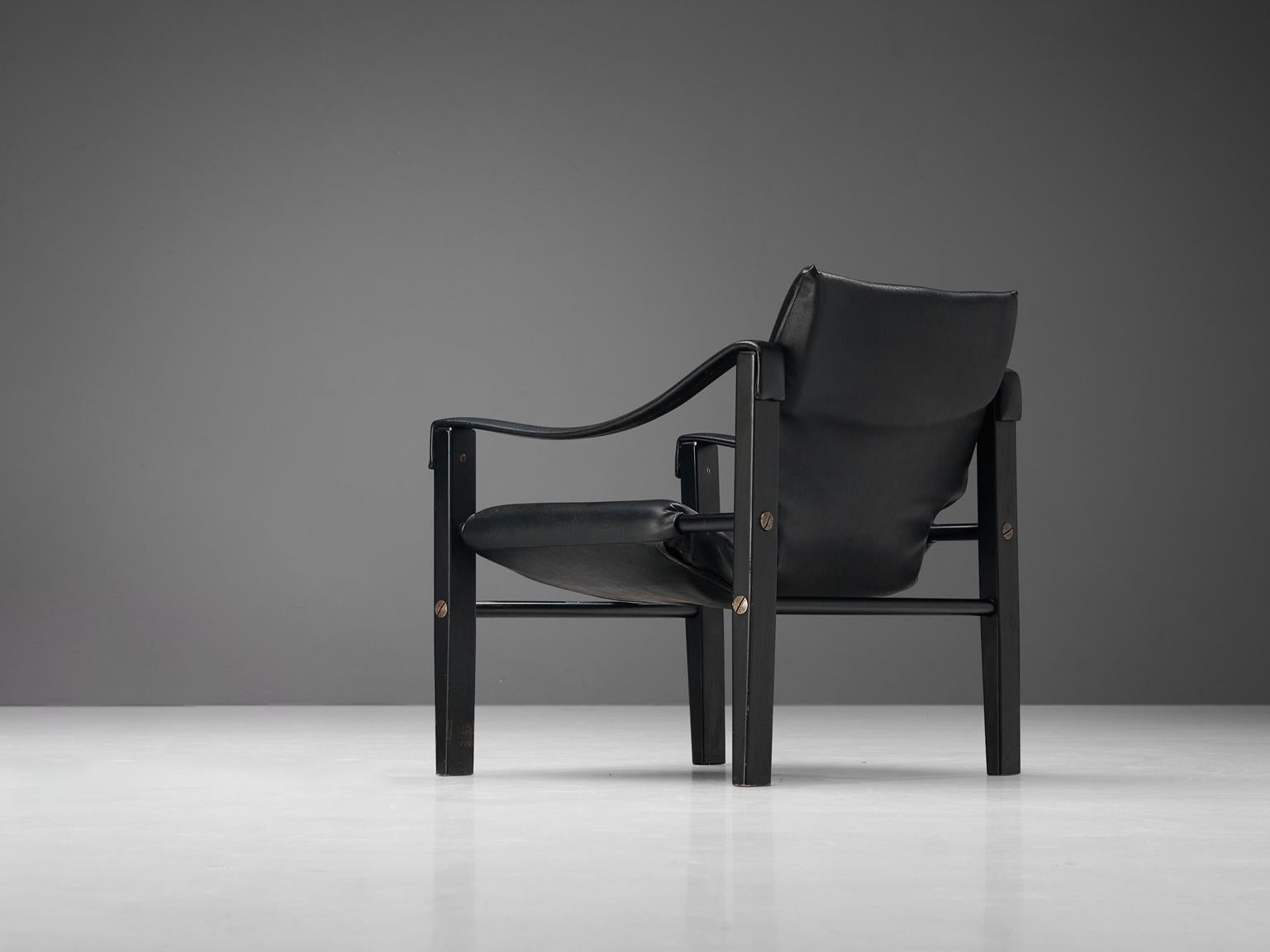 'Safari' lounge chair, vinyl, lacquered wood, metal, United Kingdom, circa 1965

This well-constructed armchair has a solid appearance. The frame is made up of four cube-shaped legs and tubular cross connections. Another feature that is