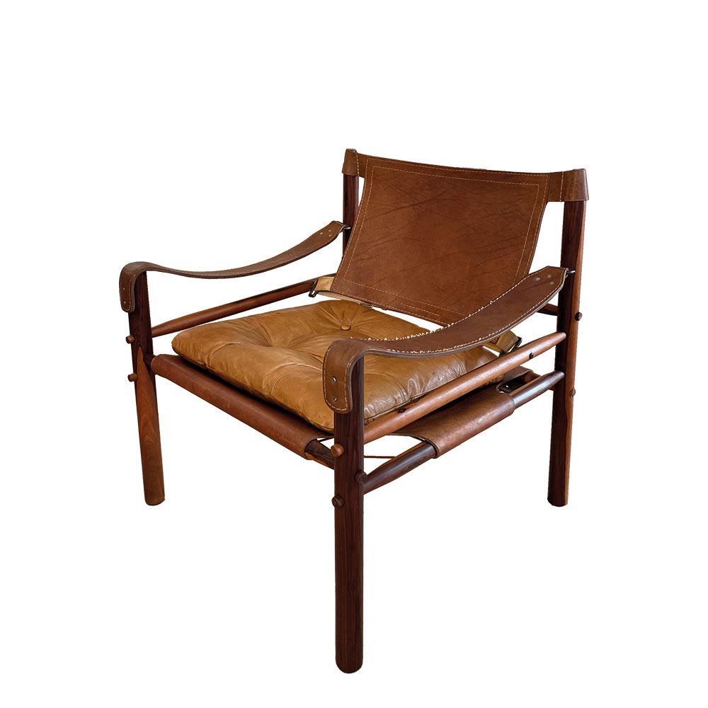 Magnificent vintage “Sirocco” armchair in safari leather designed by Arne Norell. Inspired by Klint's safari chair from 1933, Norell created his own version, which became an iconic piece of the designer. With beautiful proportions, it gives special