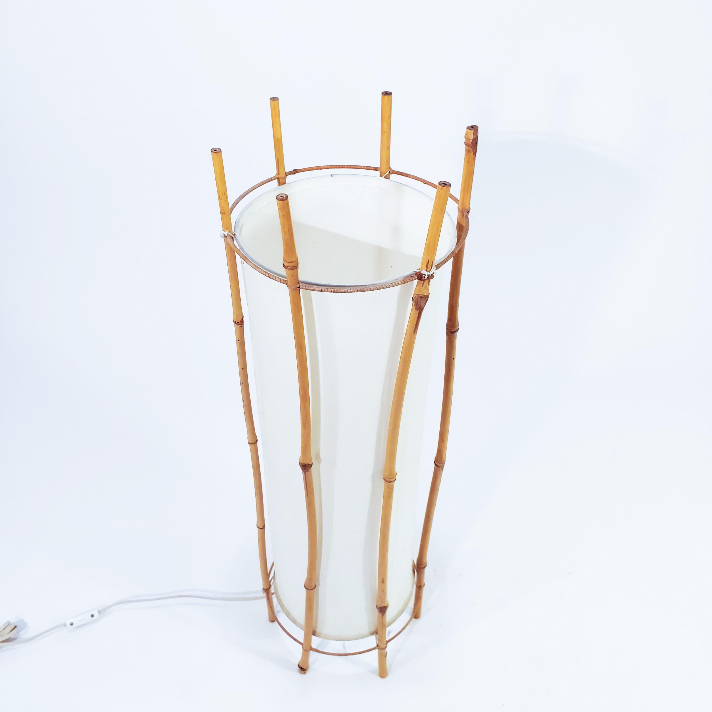 Floor lamp or table designed by the French architect Louis Sognot and made in Italy in the 60s. The structure is made of cane and rattan and the screen is made of marfil colour fabric. Sognot dedicated himself to the design of furniture with Art