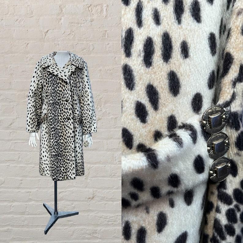 Gorgeous vintage cheetah pattern coat
beautiful & lush faux fur
notch collar
slant pockets
four button closure
+ two extra buttons
black satin lining
half belt at back
decorative metal disc on either side of the belt
coat is incredibly soft and