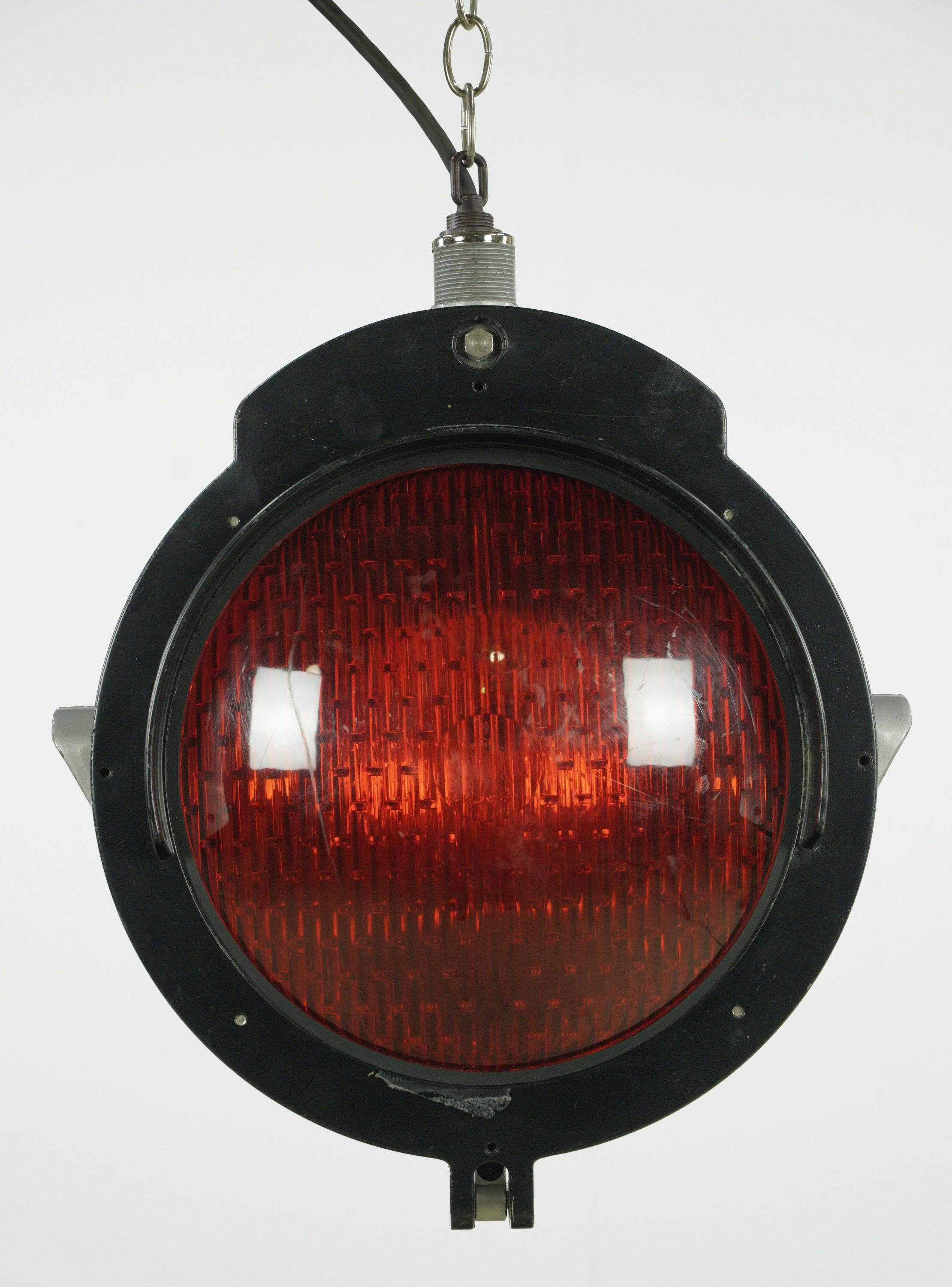 Black aluminum rail yard railroad pendant light with red glass. Made by Safetran Systems Corp. Ceiling canopy available. Good condition with appropriate wear from age. Cleaned and restored. Small quantity available at time of posting. Please