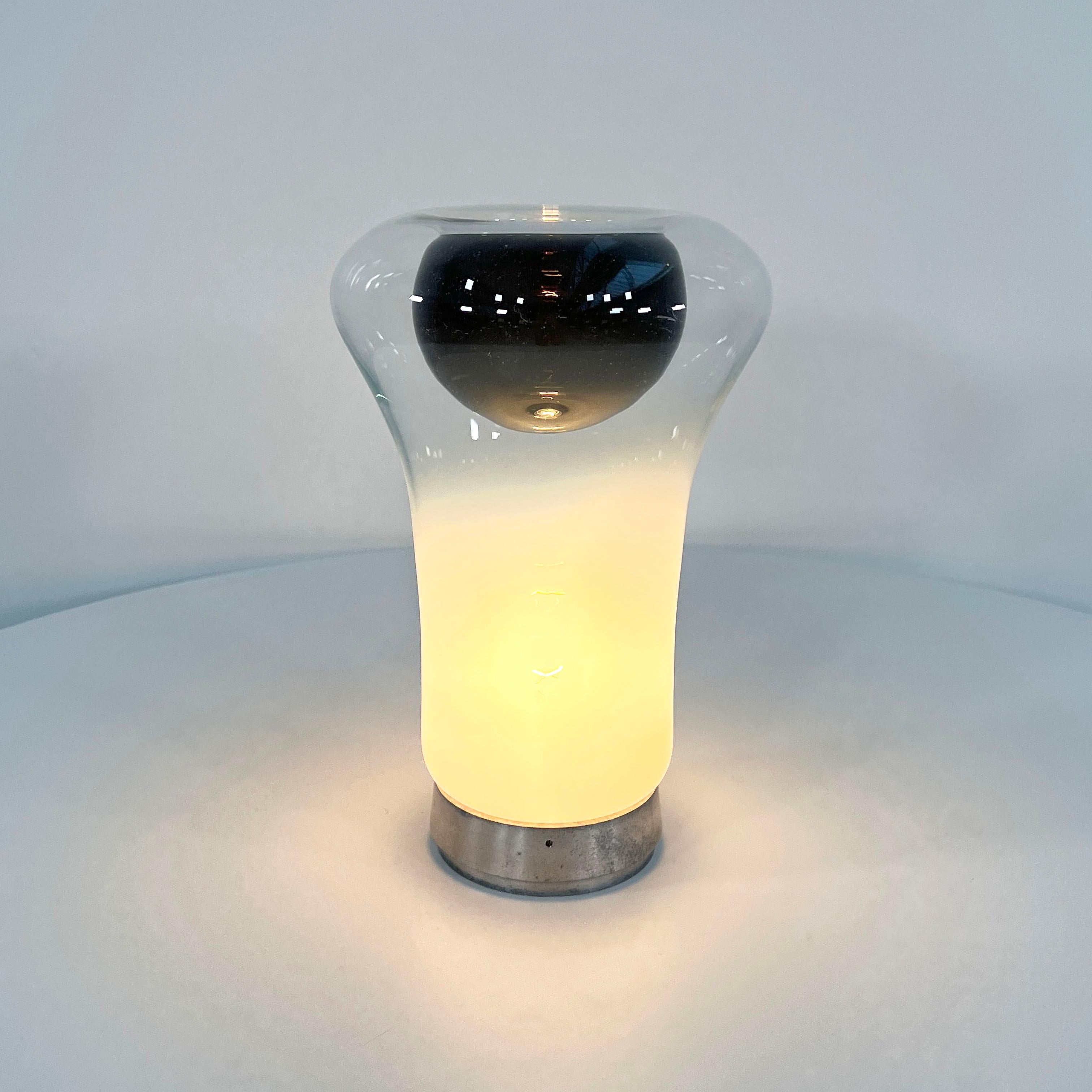 Designer - Angelo Mangiarotti
Producer - Artemide 
Model - Saffo Table Lamp
Design Period - Seventies
Measurements - Width 21 cm x Depth 21 cm x Height 33 cm
Materials - Glass, Aluminum
Color - White, Black
Light wear consistent with age and use.