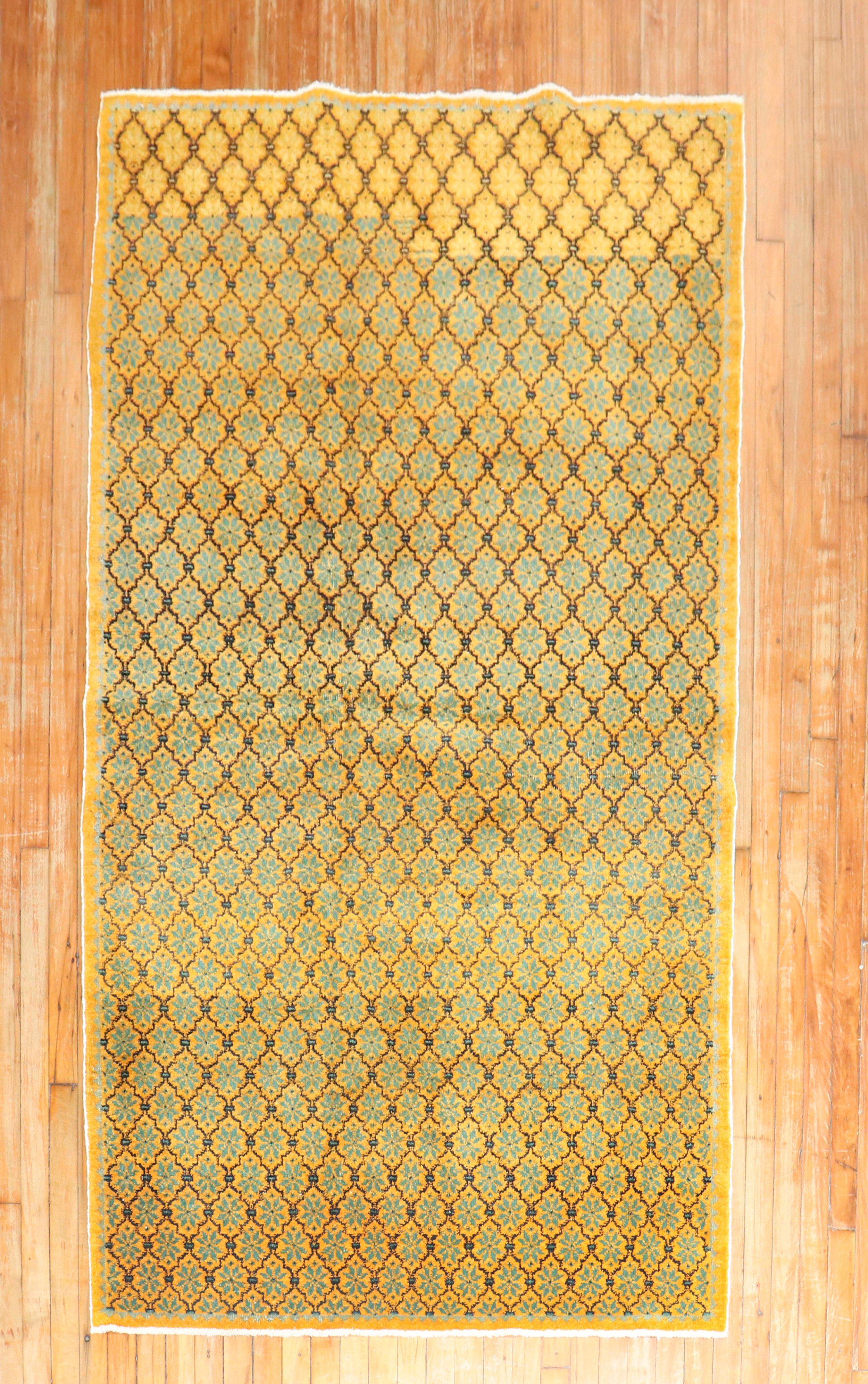 A mid-20th century Turkish rug with an all-over repetitive floral motif in green and brown on saffron field

Measures: 4'3'' x 7'5''.