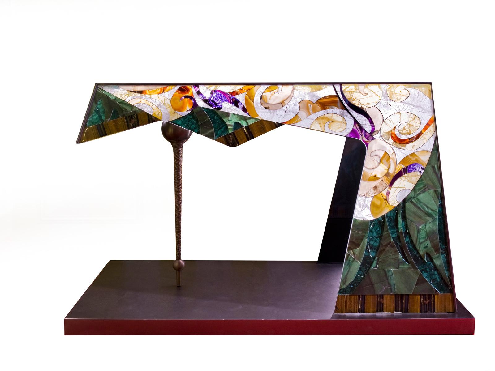 This one-of-a-kind console will create a mesmerizing focal point in an entryway or living room, in an eclectic and modern decor. The unstructured, geometric Silhouette is crafted of glass covered with a mosaic of semi-precious stones: malachite,