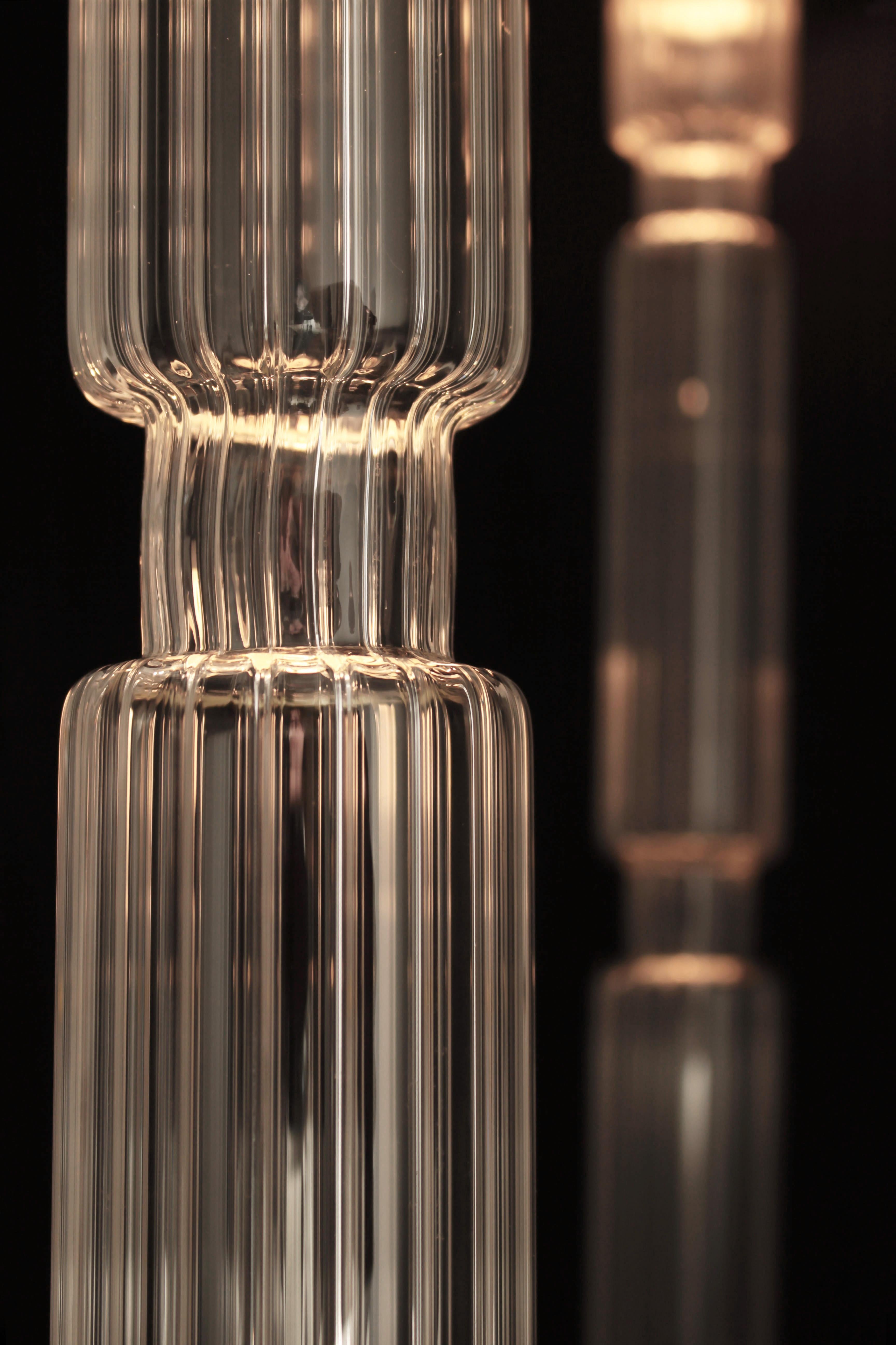 5 lights Sagano collection glass columns on a 60 cm round canopy.

Inspired by a Japanese bamboo forest, this collection's symmetrical lines and the grooves in its glasses allow a diffusion of soft light in your interiors. 
With its vertical glasses