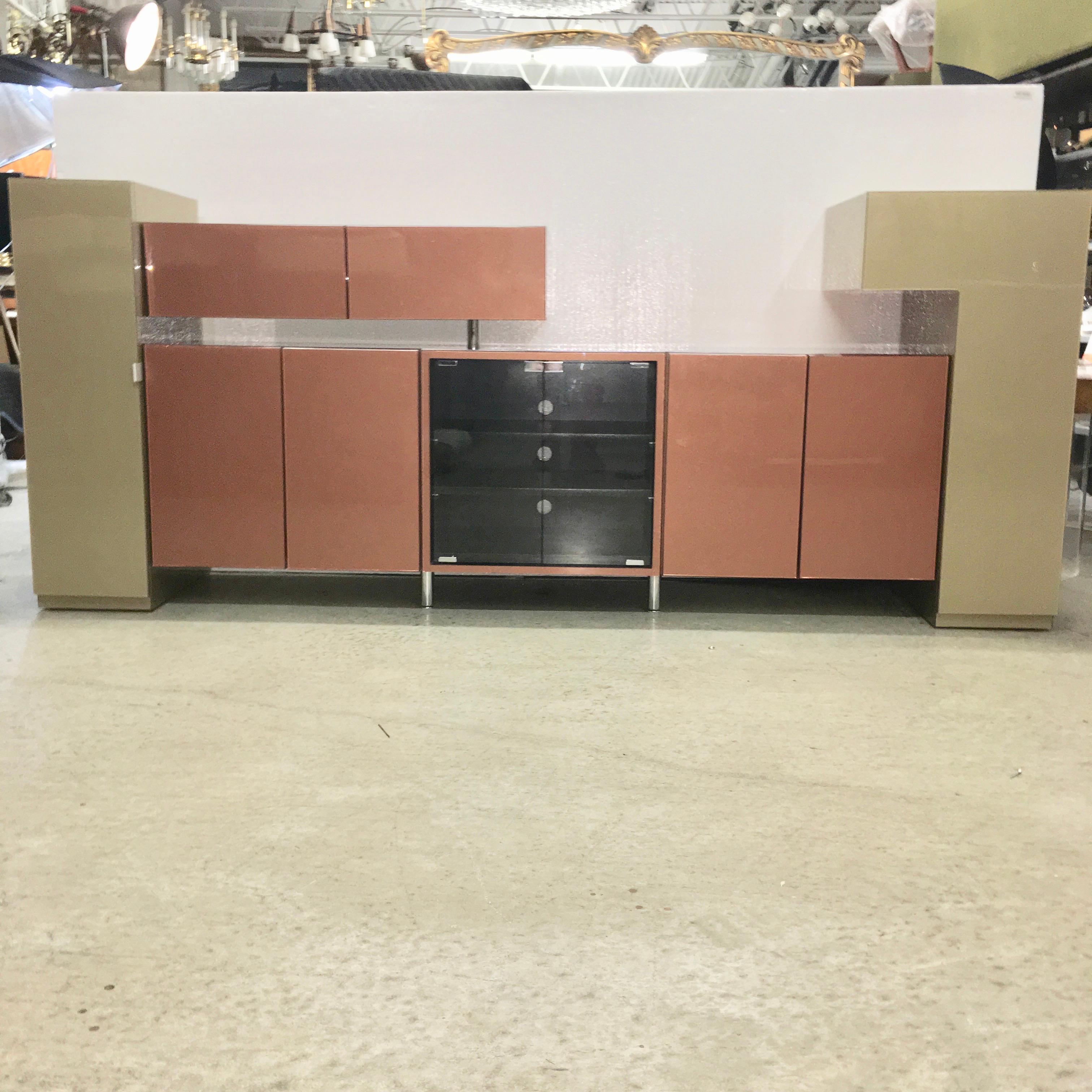Media console cabinet is clad in a deluxe glossy laminate with metallic sage green and metallic copper under a clear glossy epoxy-like finish. It is a special Formica type material I've never seen before. No damage, no dings, no flaws. Chrome