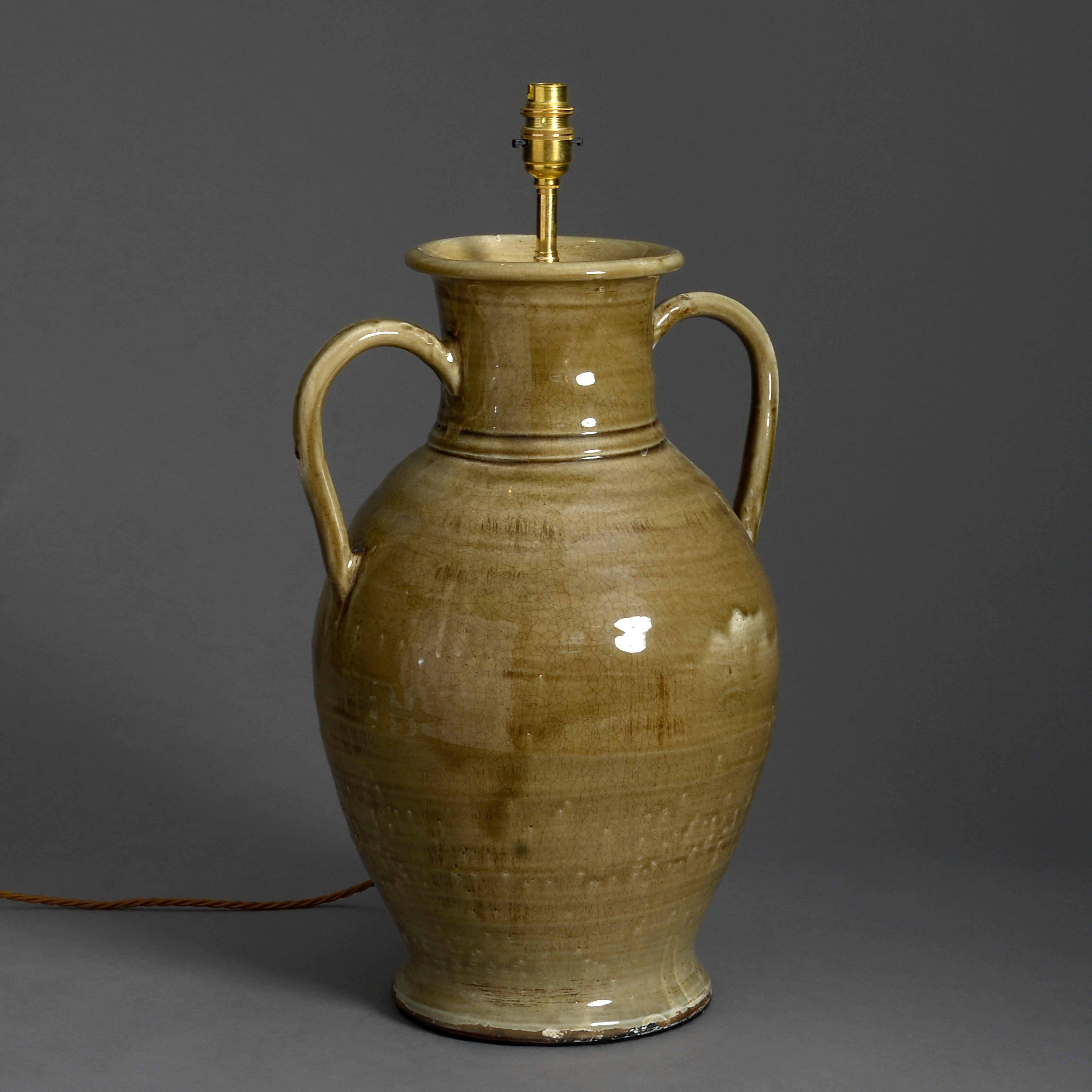 A large sage green glazed pottery two-handled vase now mounted as a lamp.

Height refers to vase only.



 