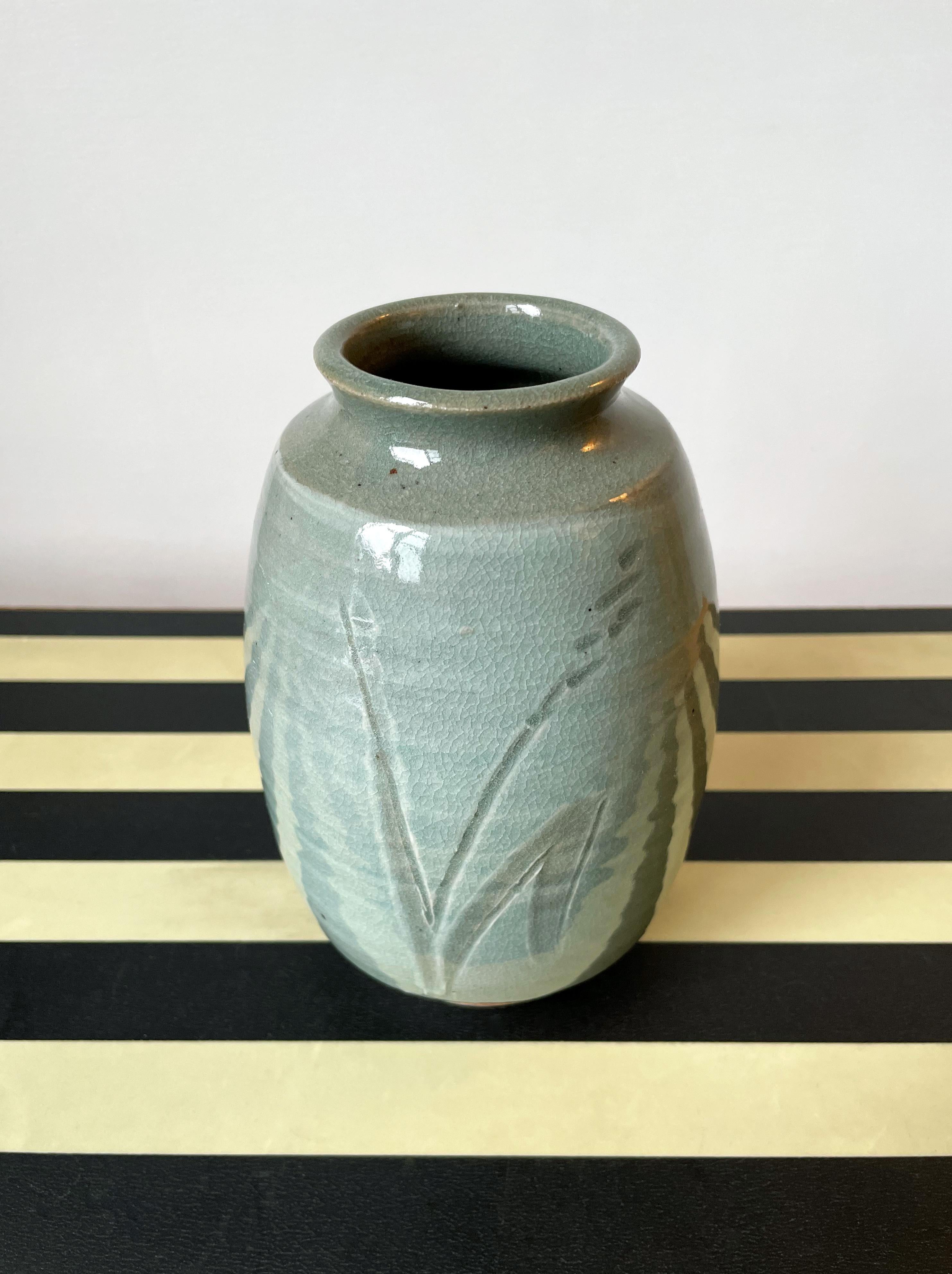 Heavy sage green Mid-Century Modern barrel shaped ceramic vase with handmade incised organic floral decor. Stamp under base. In great vintage condition consistent with age and wear. 
Scandinavia, 1950s.