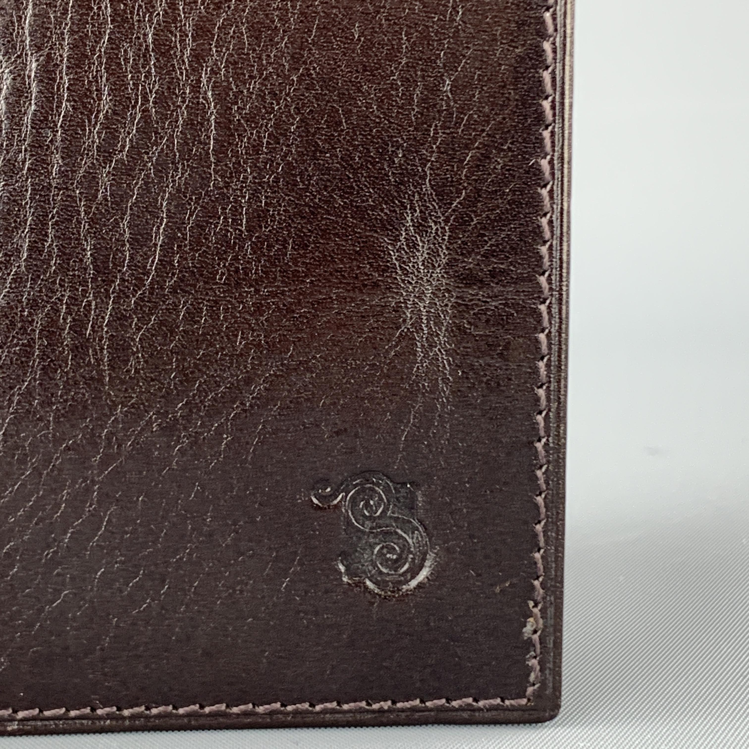 SAGEBROWN passport holder comes in dark wine toned brown leather with a logo stamp and burgundy interior.

Good Pre-Owned Condition.

4 x 6 in.