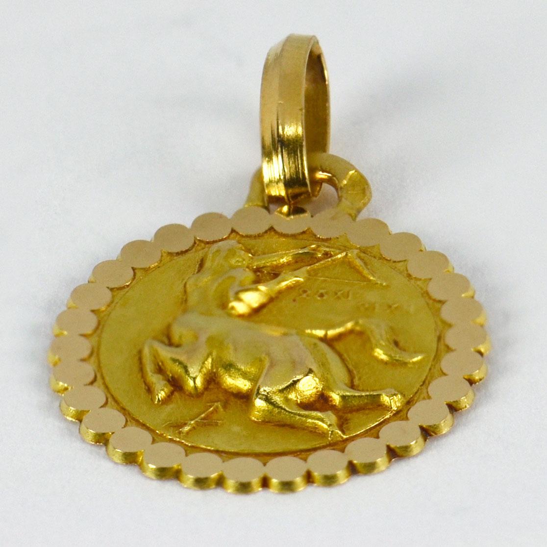 An 18 karat (18K) yellow gold charm pendant designed as the zodiac symbol for Sagittarius, depicting a centaur with bow and arrow, the astrological symbol for Sagittarius and the dates 23 November - 21 December. Stamped with the eagle’s head for