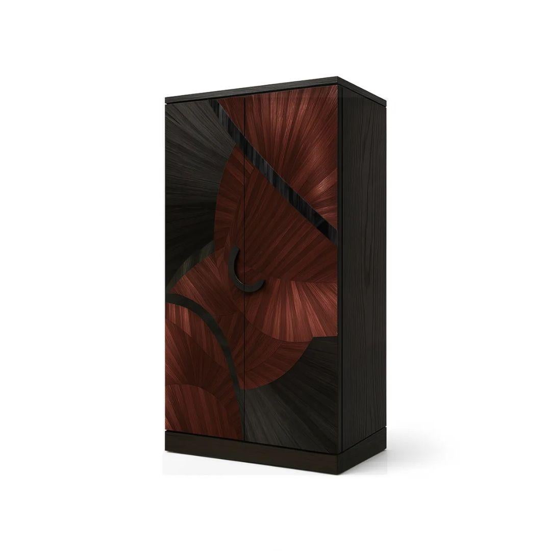 The Sahara Straw Armoire by KOKET showcases bold curves in radiant straw marquetry over a rich dark backdrop, forming a striking rhythm of color and form. With a seamless silhouette and luxurious black tulipwood interior, it’s a statement of
