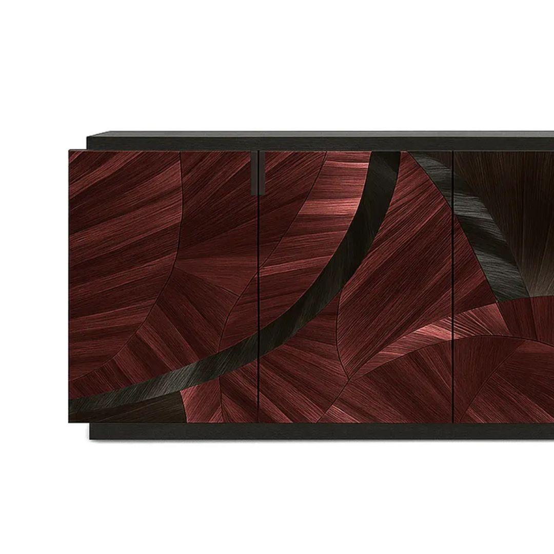 The Sahara Straw Cabinet by KOKET features flowing arches of warm straw marquetry over a dark strié backdrop, creating an abstract sense of movement. With a seamless design and matte black tulipwood interior, it’s a bold fusion of art and