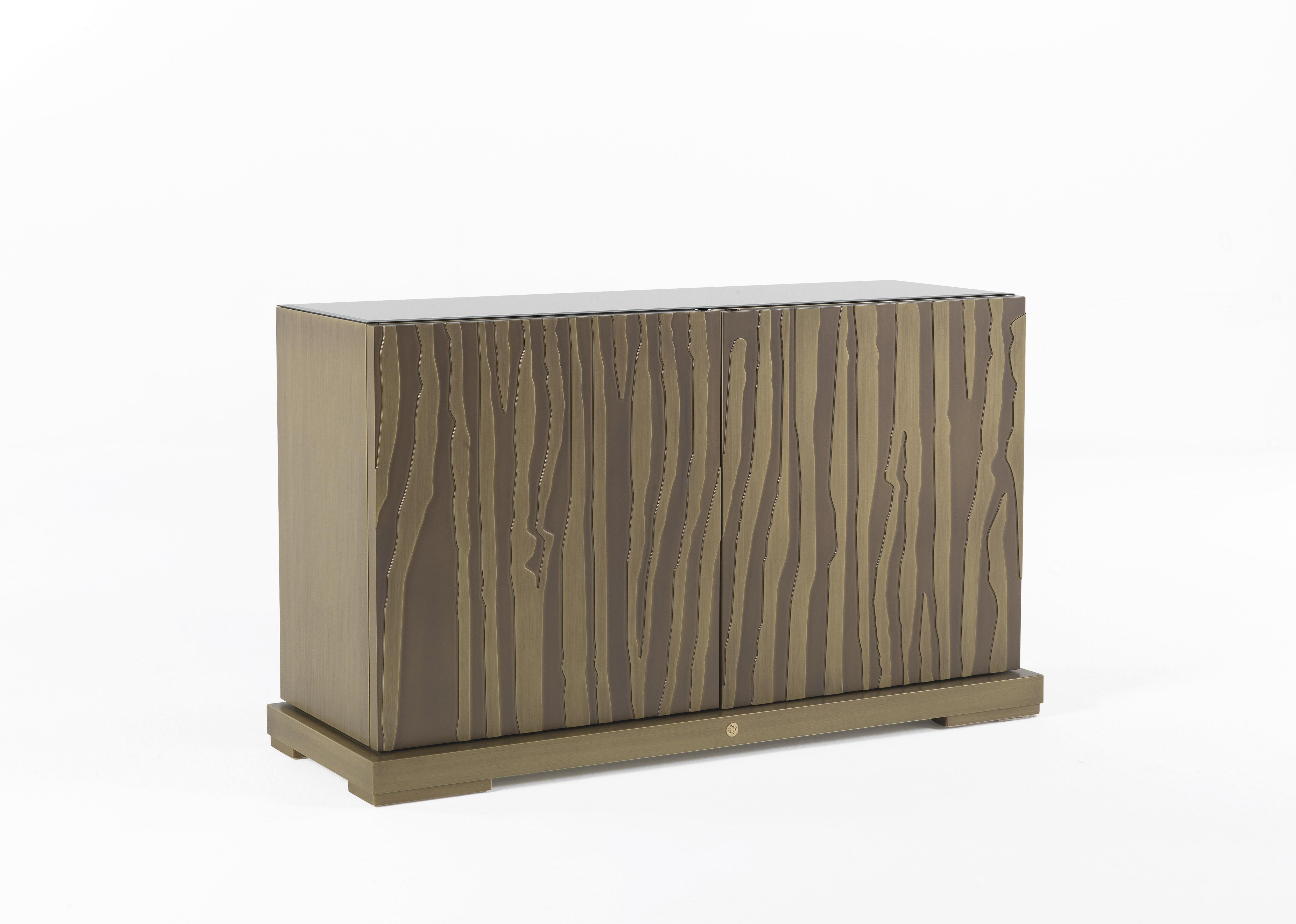 Sahara Madia with top in multi-layer wood covered with bevelled bronze mirror. Structure and engraved doors in multi-layer wood lacquered brushed bronze finishing. Metal feet brushed bronze finishing. Inside finishing in microfiber with bronze glass