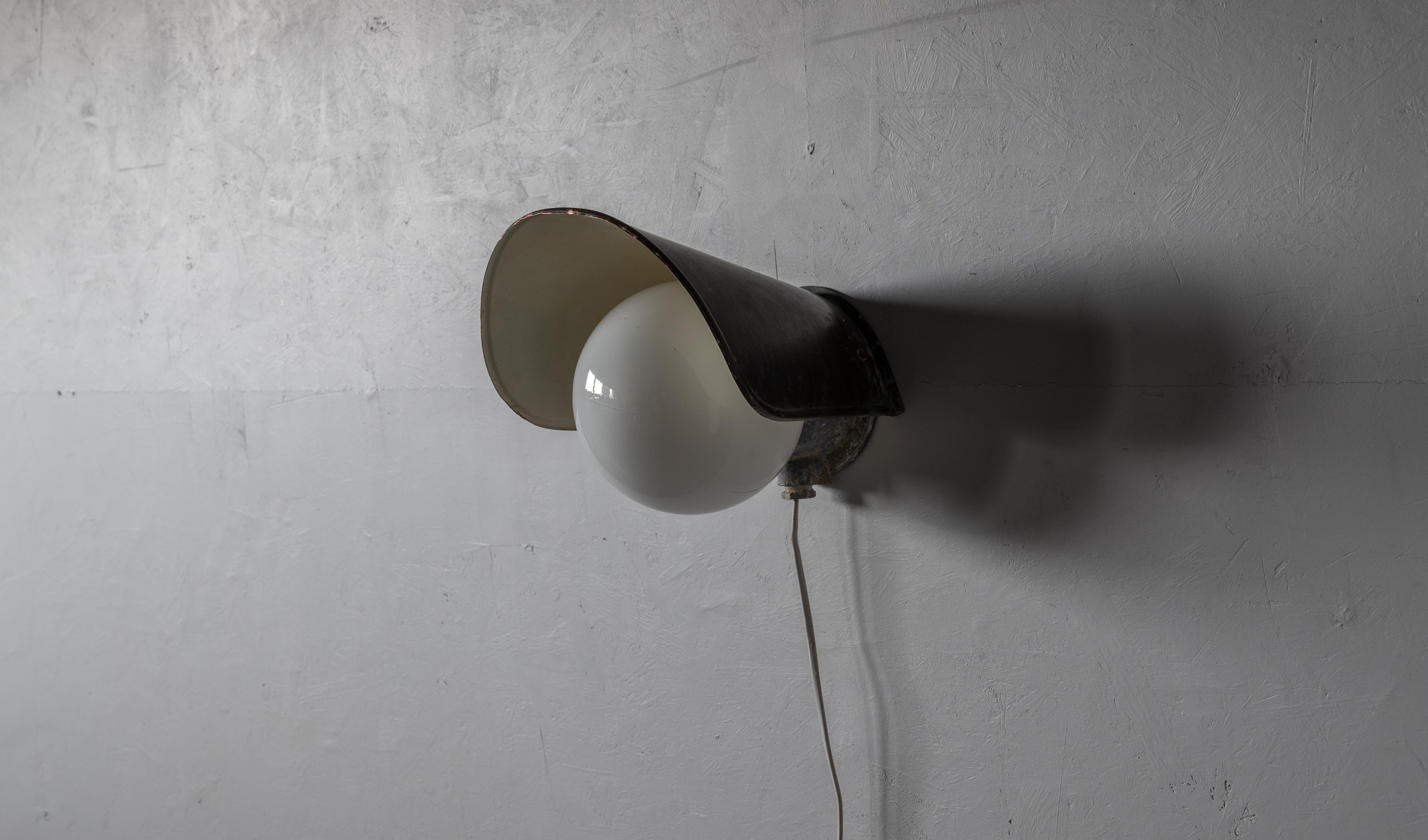 A wall light, designed and produced by Sähköliikkeiden Oy, Finland, 1930s-1940s.

Features copper and milk glass. 

Has retained dramatic patina, likely utilized as an outdoor light.