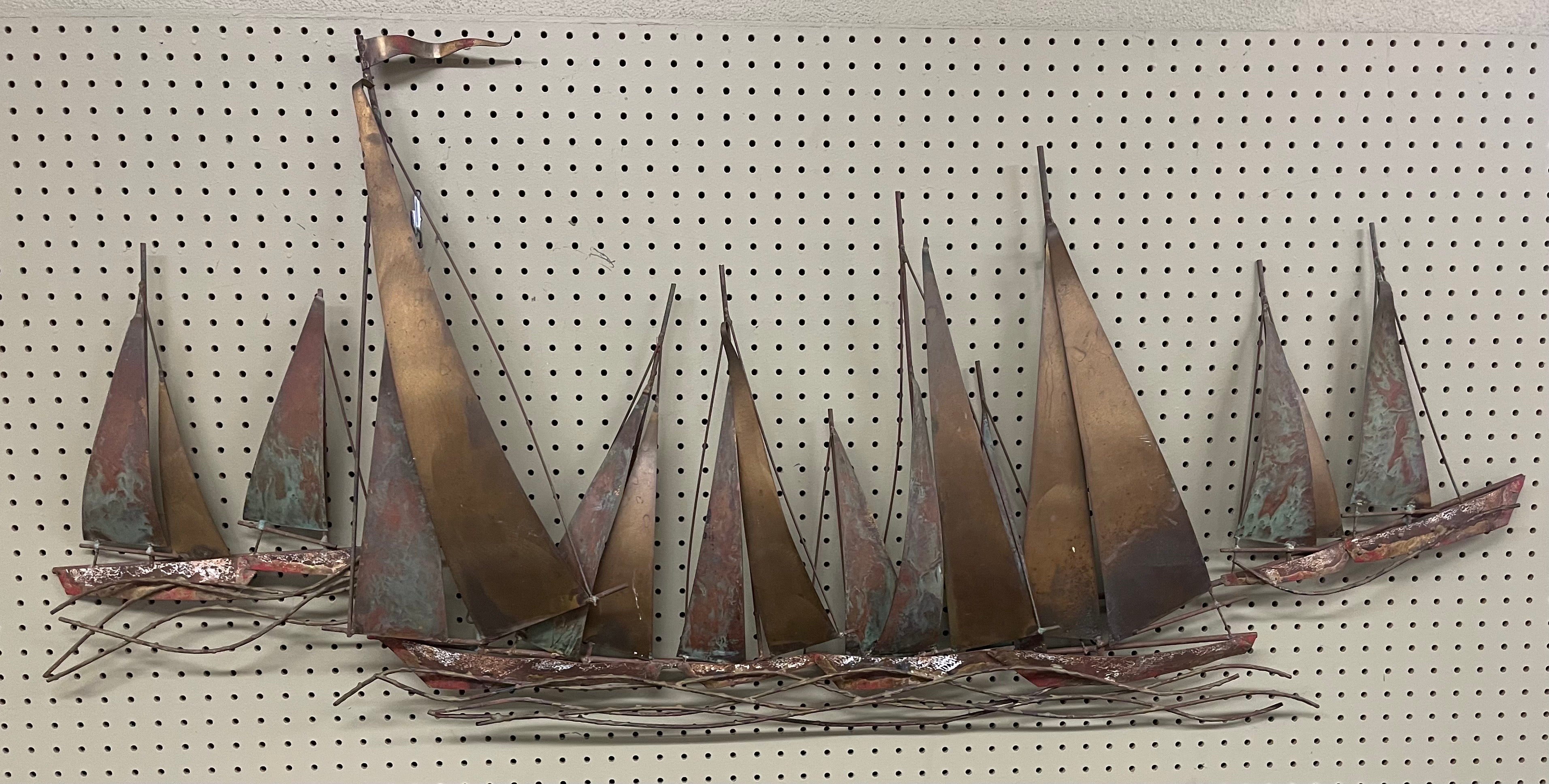 Super rare and very hard to find sail boat regatta mixed metal wall sculpture by C. Jere for Artisan House, circa 1970s. The piece, depicting a sailboat regatta out at sea, is in very good condition and has great color, depth and craftsmanship. The