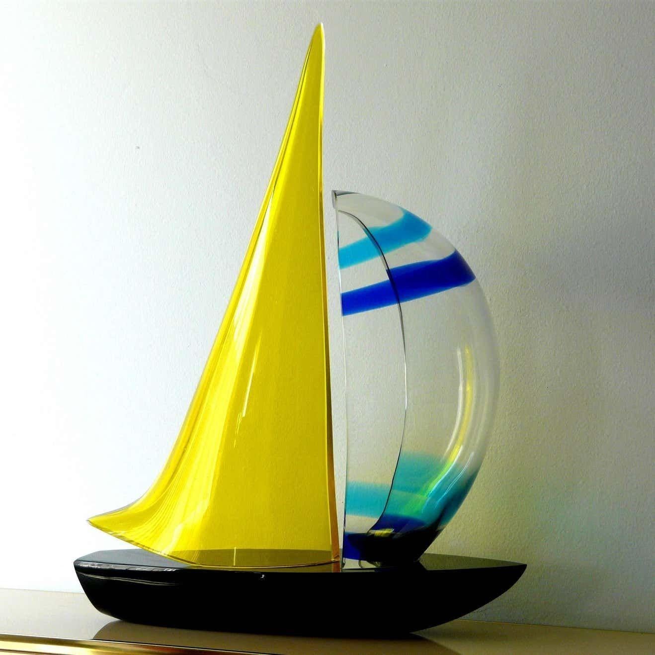 Vintage Italian double sail boat hand blown and crafted in black, yellow, clear, navy blue and baby blue Murano glass by by Romano Dona' Signed “MURANO” on the base / Made in Italy in the 1980’s
Measures: height: 25 inches / width: 21.5 inches /