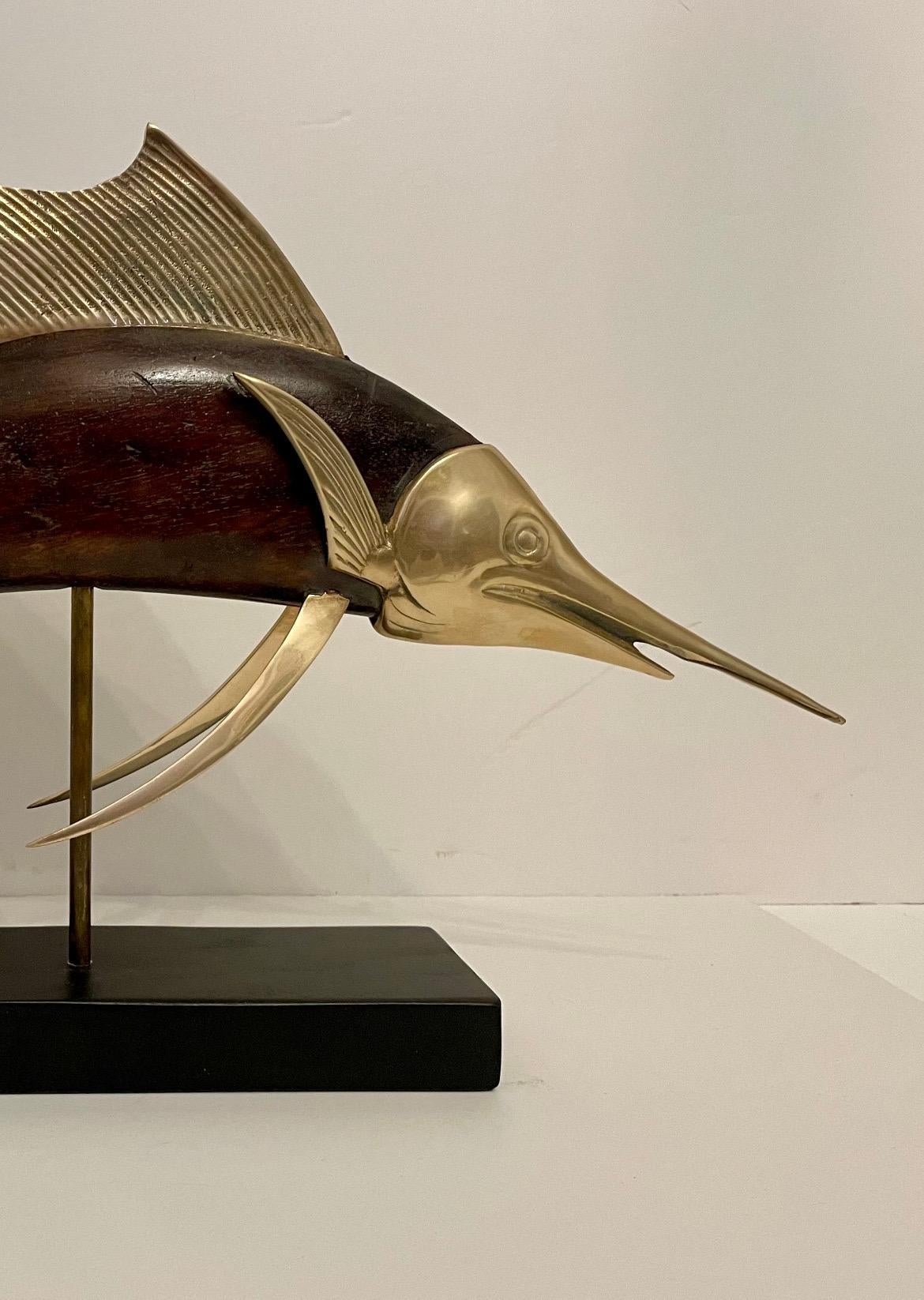 Large scale brass and mahogany full body sailfish sculpture mounted on a rectangular black wood base. By Frederick Cooper, circa 1950's-1960's. Good overall condition with some wear to finish from age and use. Some patina on brass
