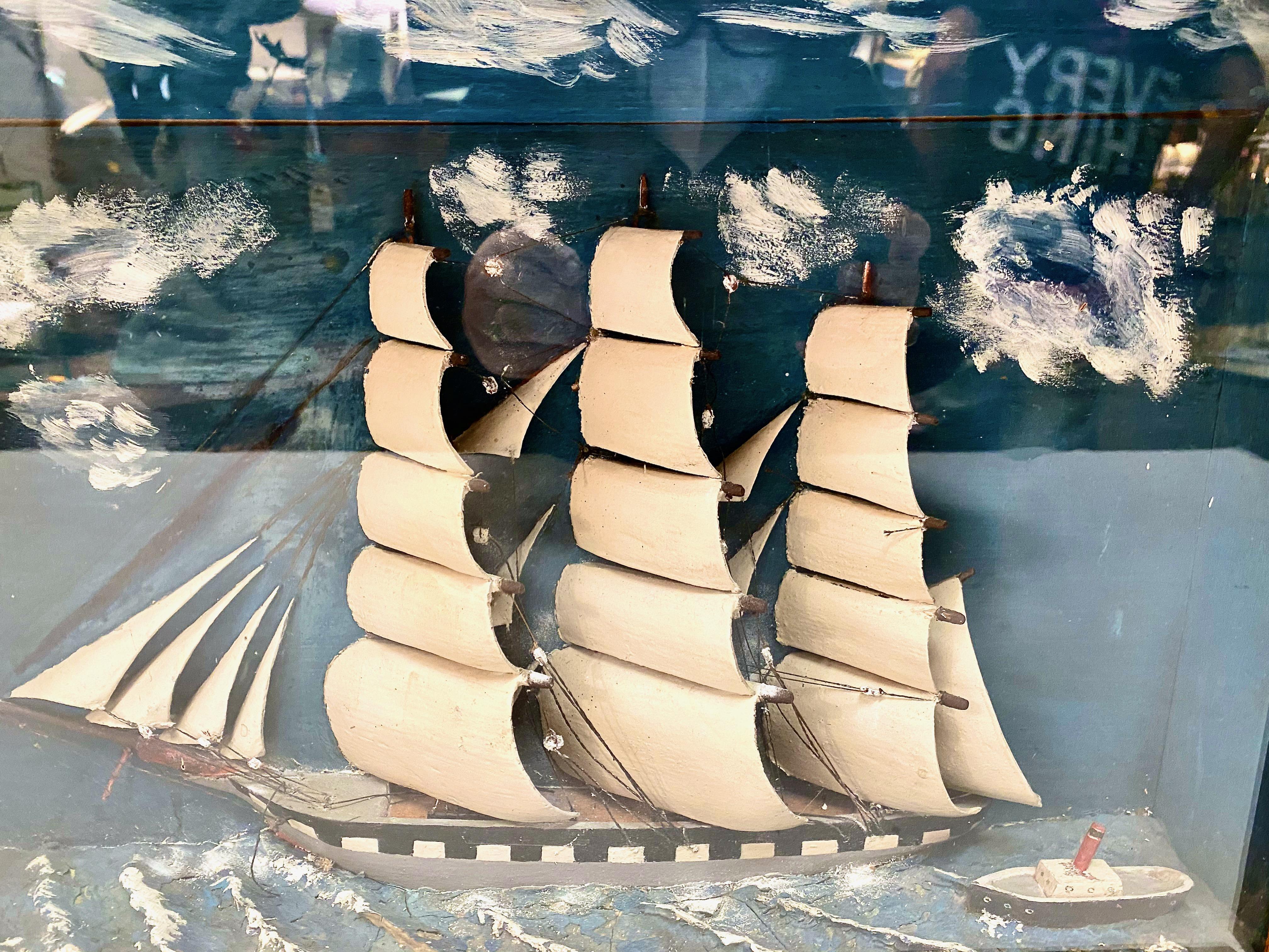 This is a beautifully detailed diorama or shadow box of a late 19th century schooner and tug boat.