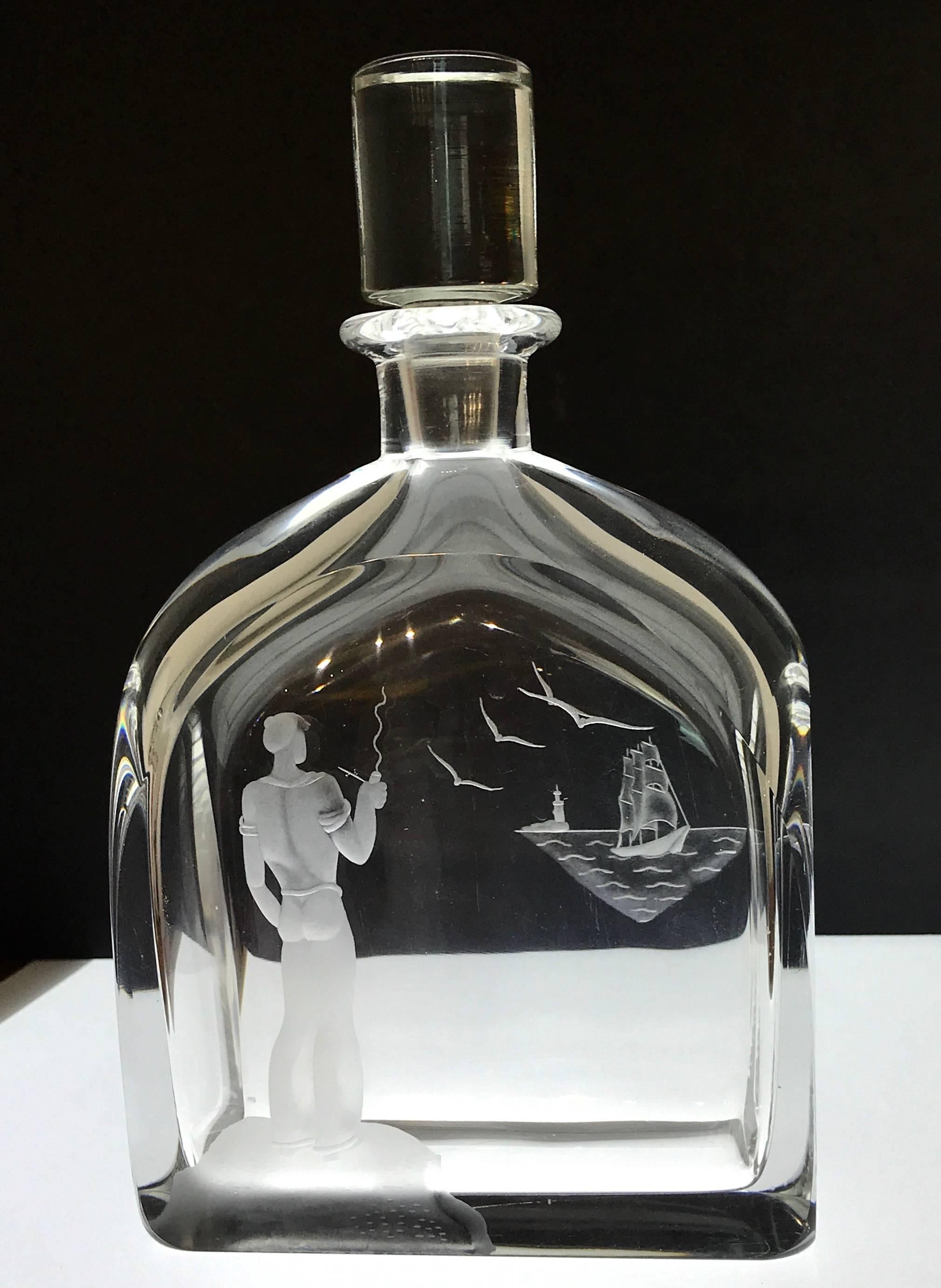 Sailor and ship motif decanter, in the style of Vicke Lindstrand, beautifully engraved. Signed with script signature and numbers.