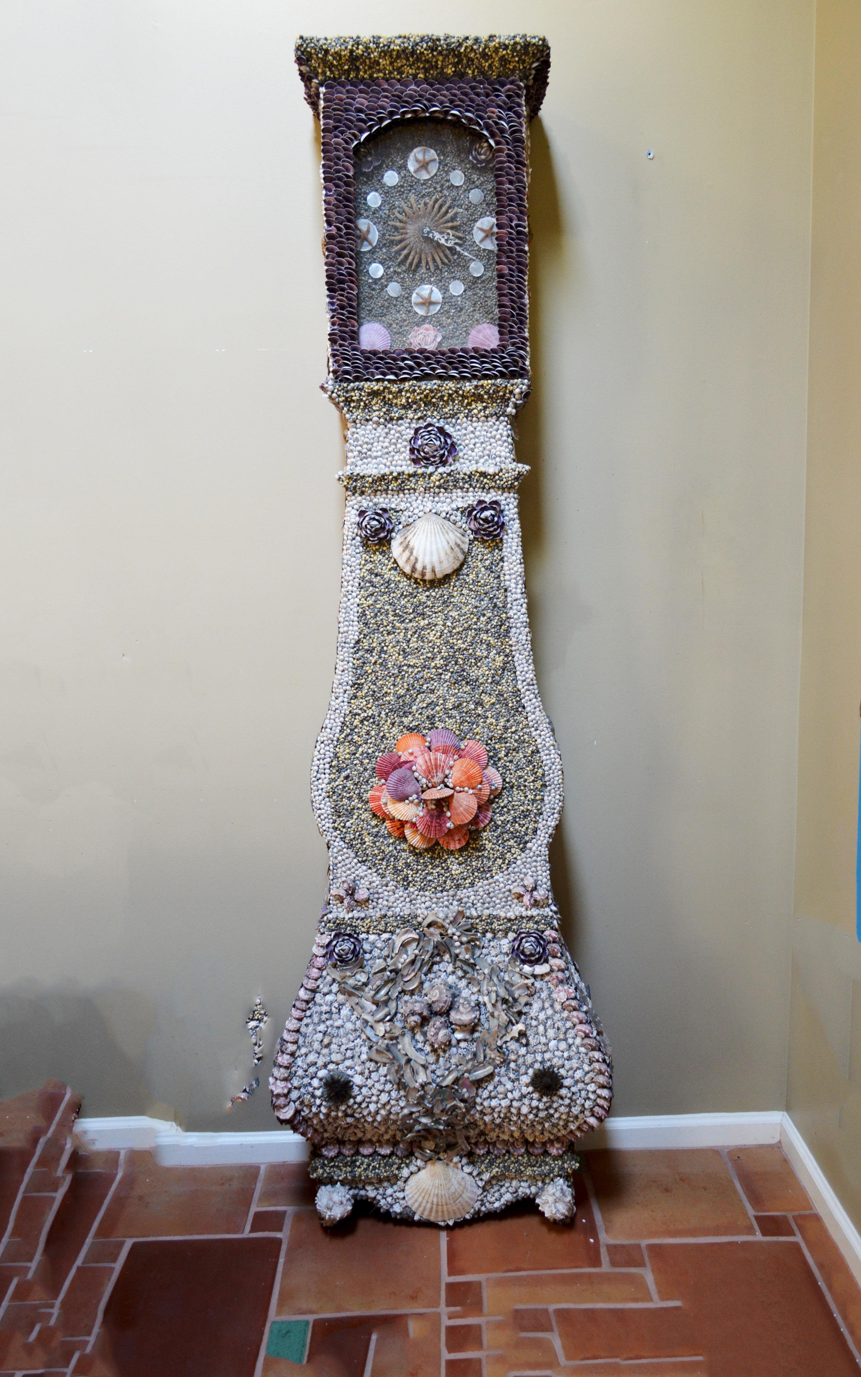 Folk art Sailor-made vintage seashell long case clock
Early 2nd half of 20th century

The shell-decorated clock consists of two pieces the hood and the body of the clock-both with a wood base. The body was decorated with a selection of different