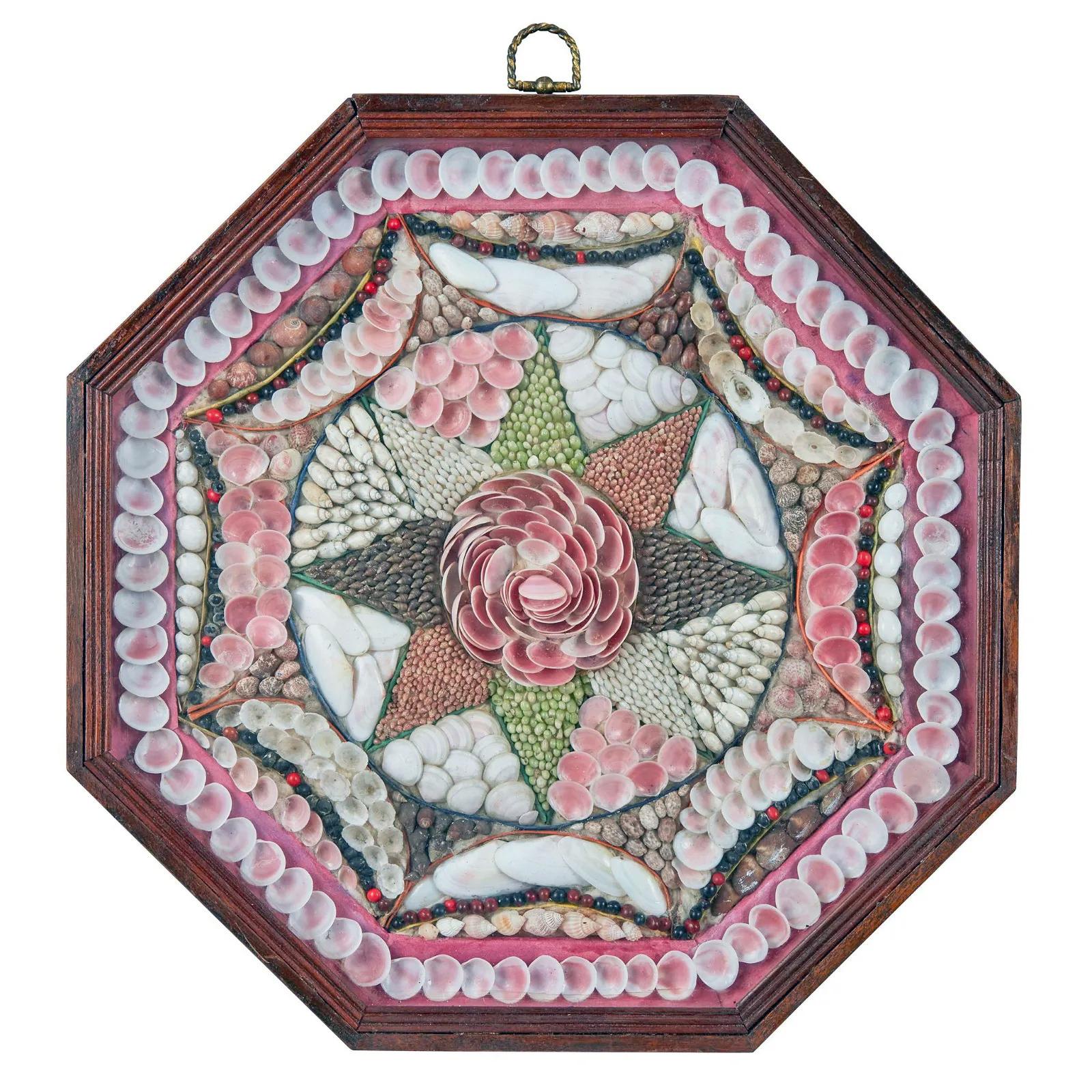 West Indian Sailor's Valentine,
Circa 1880

The large single sailor's valentine is composed of a variety of shells in concentric and geometric patterns, centered with a pink peony enclosed within a pointed star within an octagonal stained wood