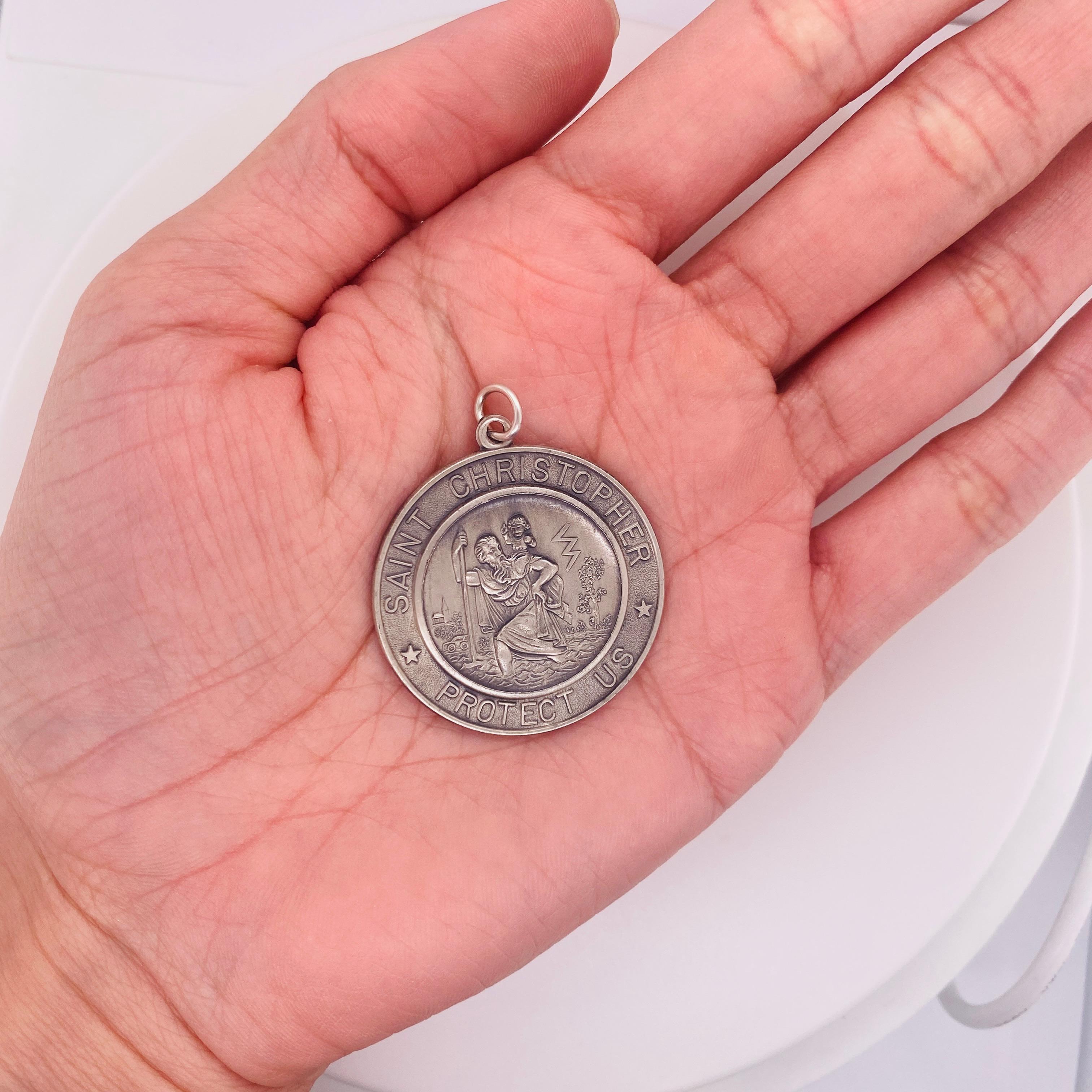 Wear this St. Christopher pendant to protect you. St. Christopher is the patron saint of travelers. Made in sterling silver, the pendant measures 1 1/4 inches in diameter (32 millimeters) and 1 5/8 inches (40 mm) in length from the top of the bail