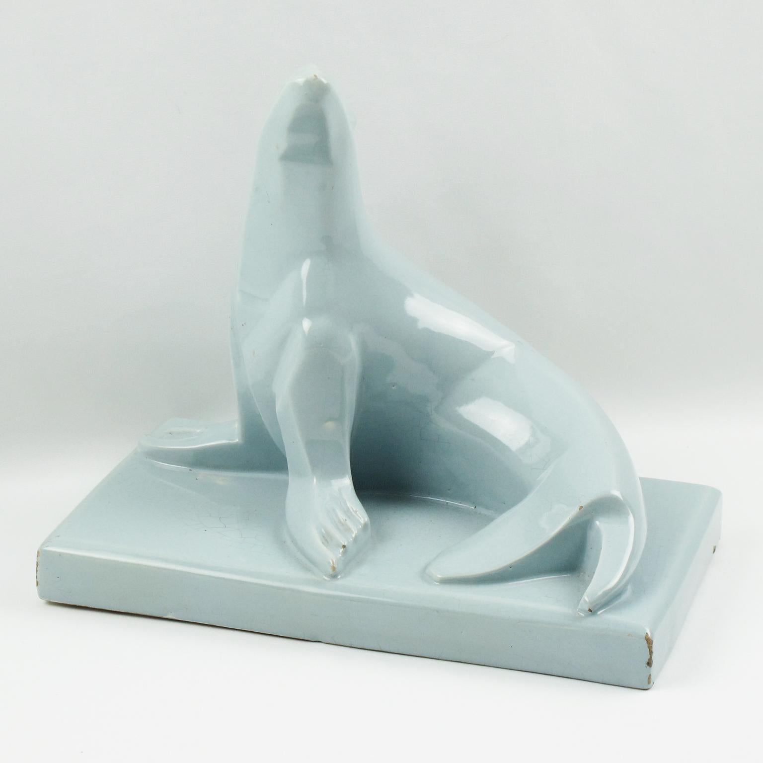 This stunning French Art Deco crackle-glazed cubist ceramic sculpture is extremely rare, both by the color and the model. The sculpture was designed and manufactured in Saint-Clement, France. The animal sculpture features a stylized seal supported
