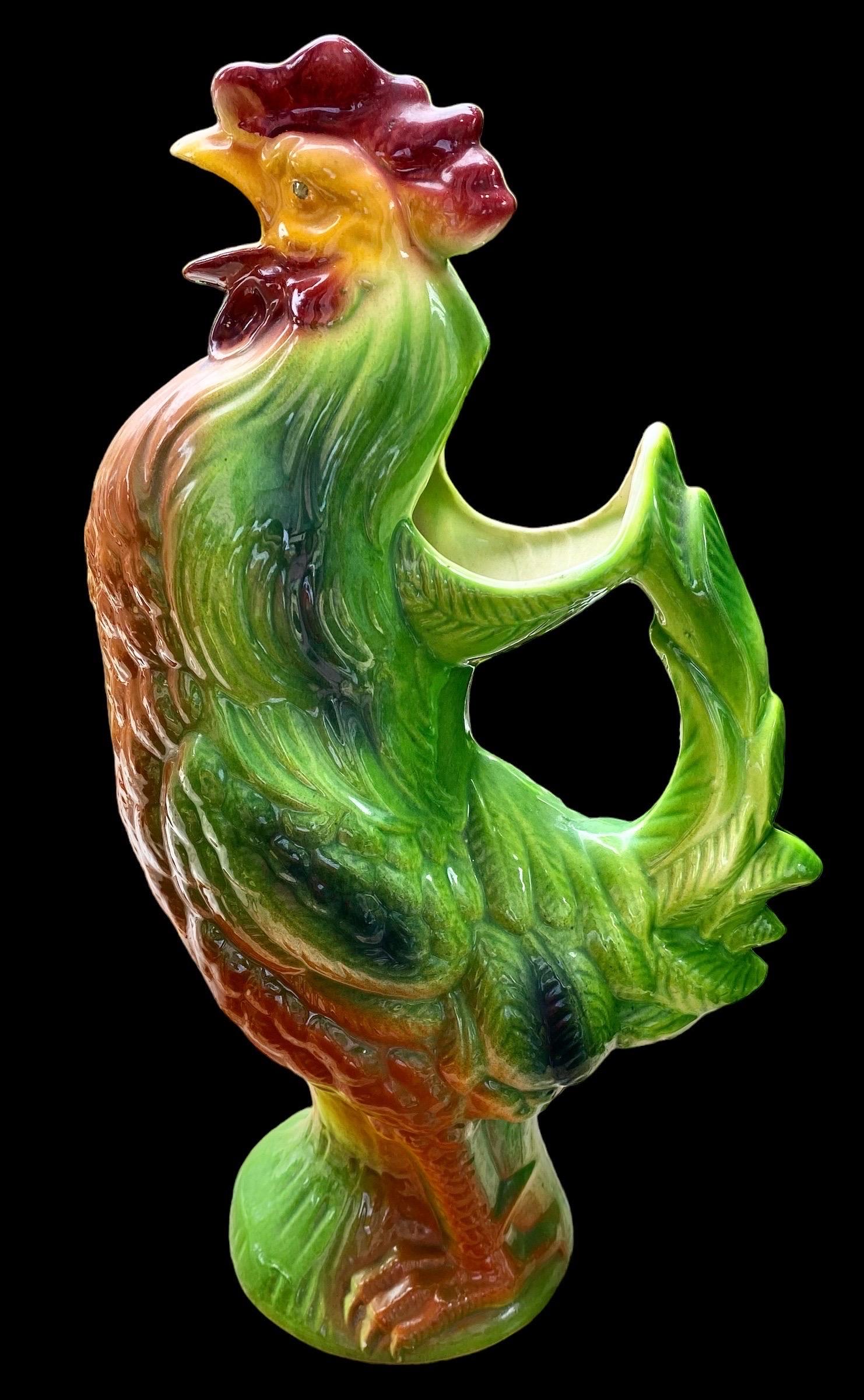 A antique French Art Nouveau Majolica glazed Absinthe water pitcher formed as a rooster, St. Clément. The Gallic rooster, in French: le coq gaulois, is an unofficial national symbol of France.
This earthenware Barbotine majolica pitcher is brightly
