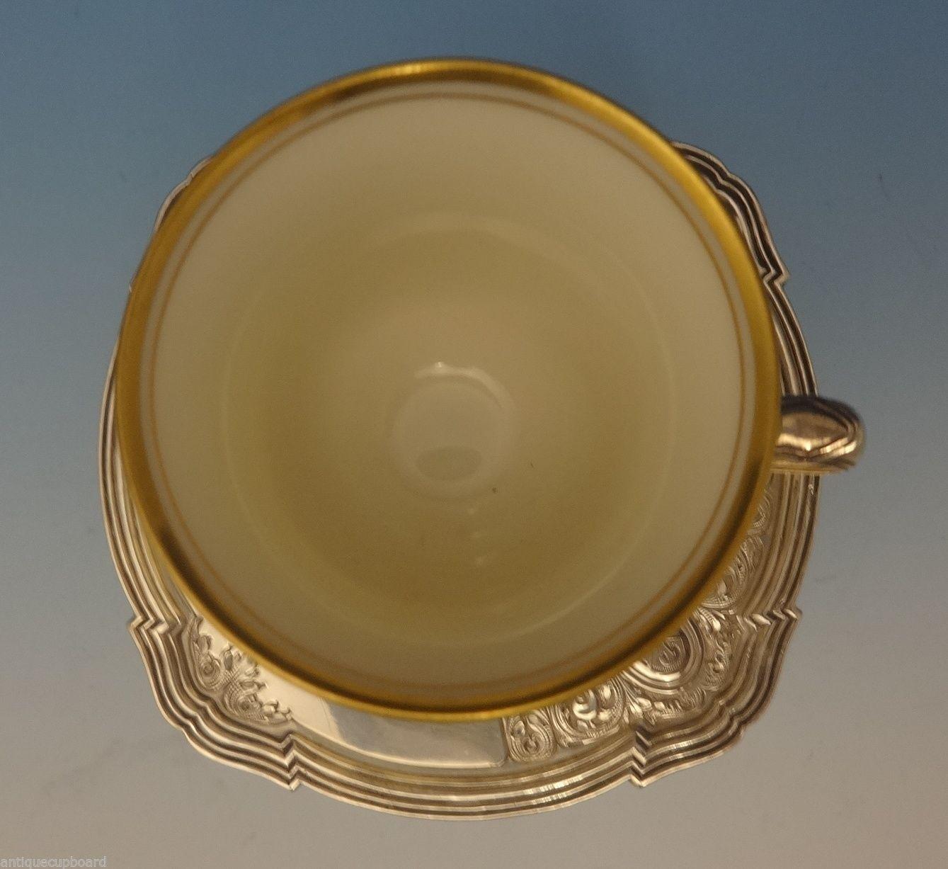 Saint Dunstan chased by Gorham sterling silver demitasse cup with saucer and liner with an R monogram. The saucer has a WKK special order mark, and the cup is a WKJ order mark. The pieces date from the 1920s. The cup with the liner measures 2 3/4