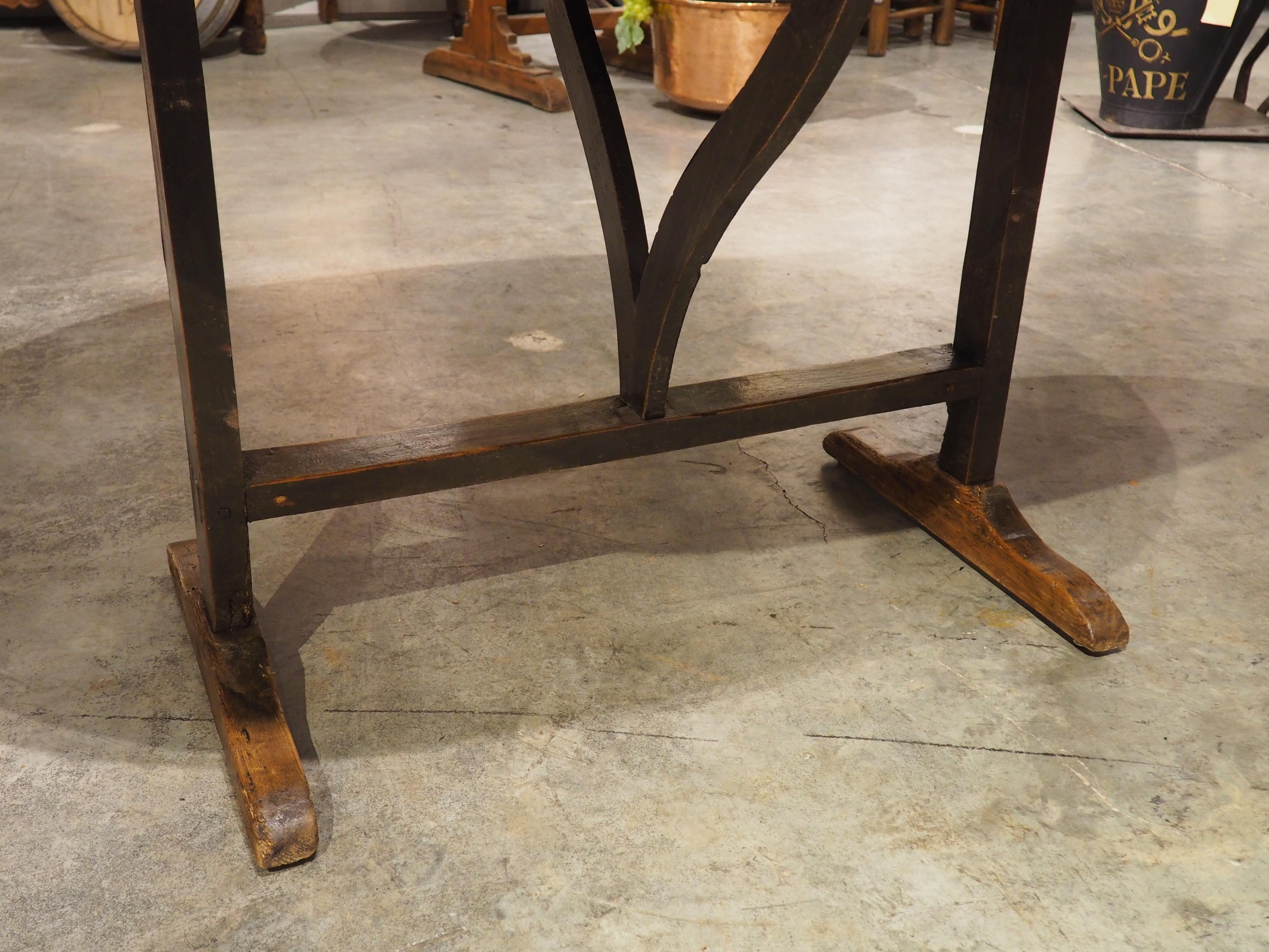 Sometimes referred to as a vintner’s table, this wine-tasting table would have been used in a French vineyard during the 1800s. The tilt-top construction allows the table to be stored discretely when not in use, but when opened up, the top features