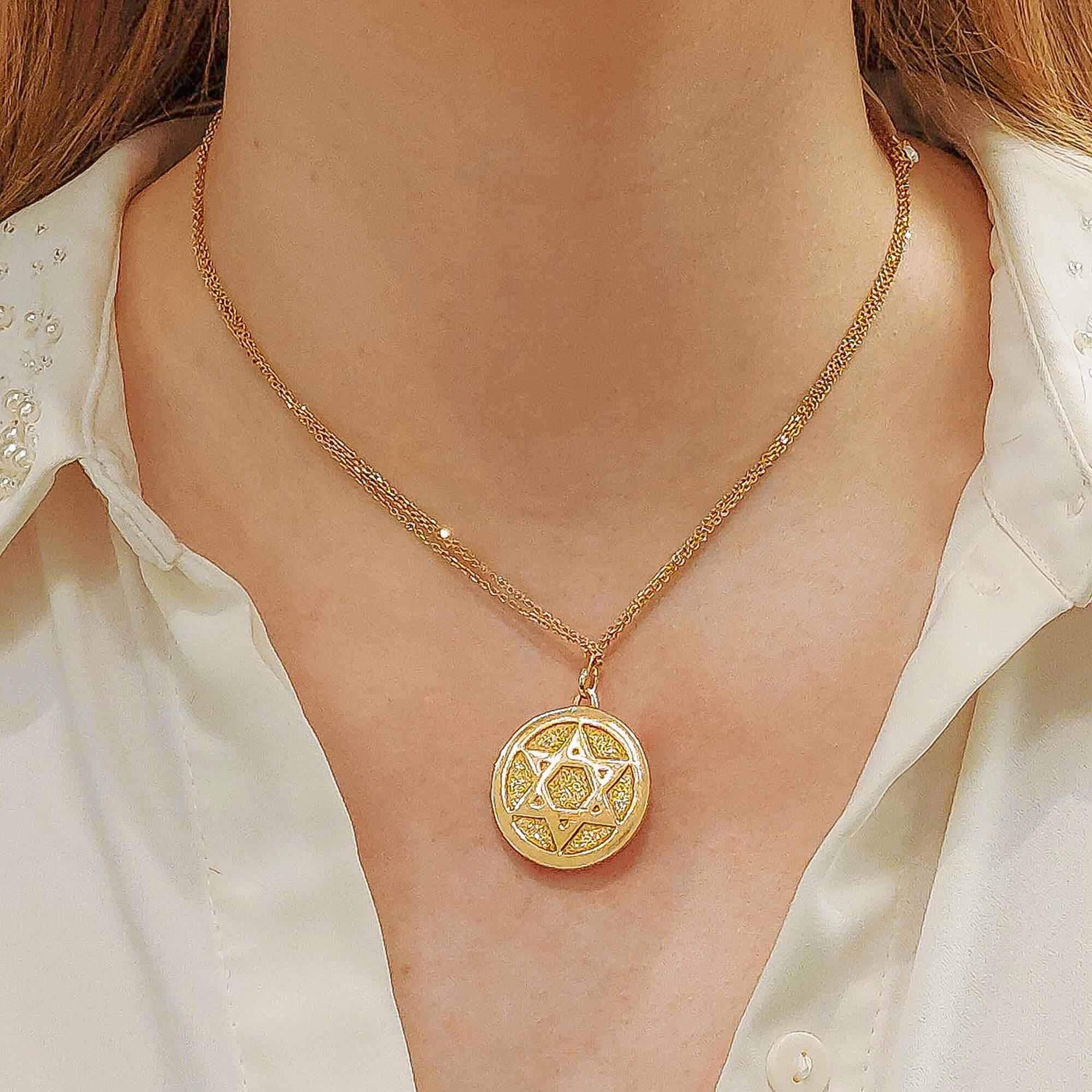 A Saint Estephe Prophet and Star-Of-David medallion pendant in 18-karat yellow gold. The medallion, which is of a hammered finish, features a three-dimensional Saint Estephe Prophet on one side and a Star-Of-David motif to reverse. 
It is secured to