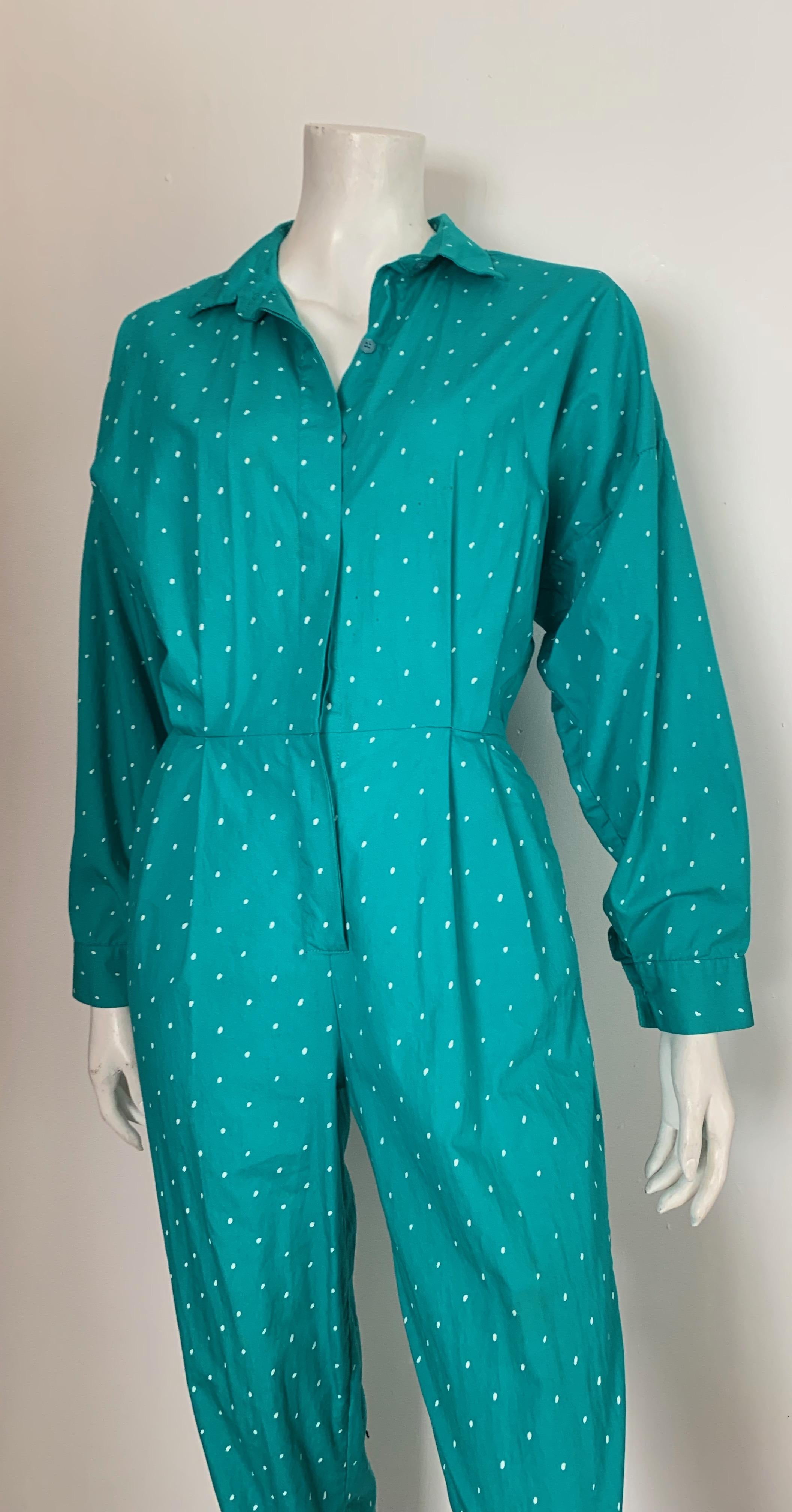 Saint Germain 1980s cotton polka dot pattern jumpsuit with pockets is a size 4. 
There is an elastic band in the back side of this jumpsuit and at the max it is 26